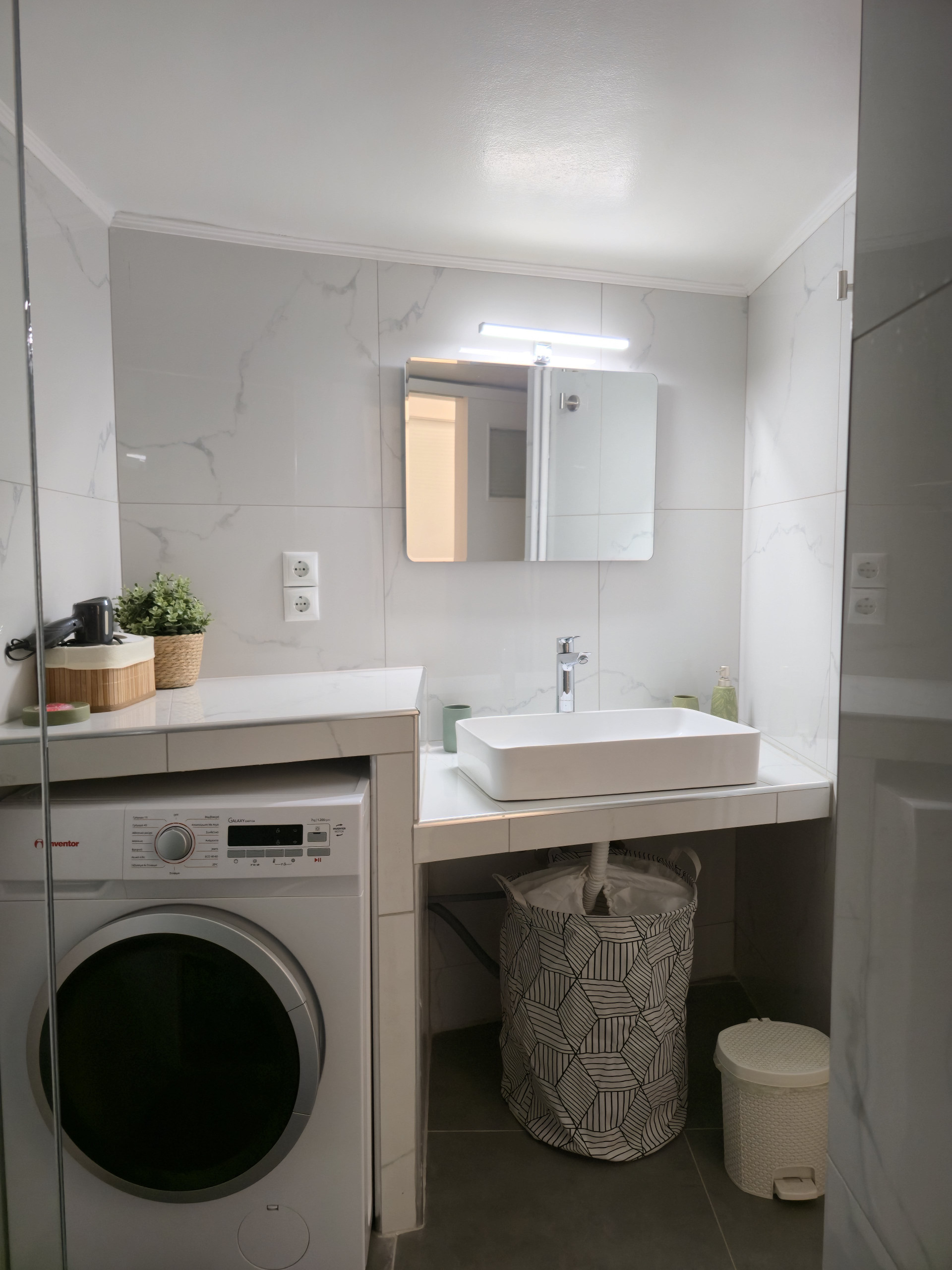 Bathroom overview with sink and washer