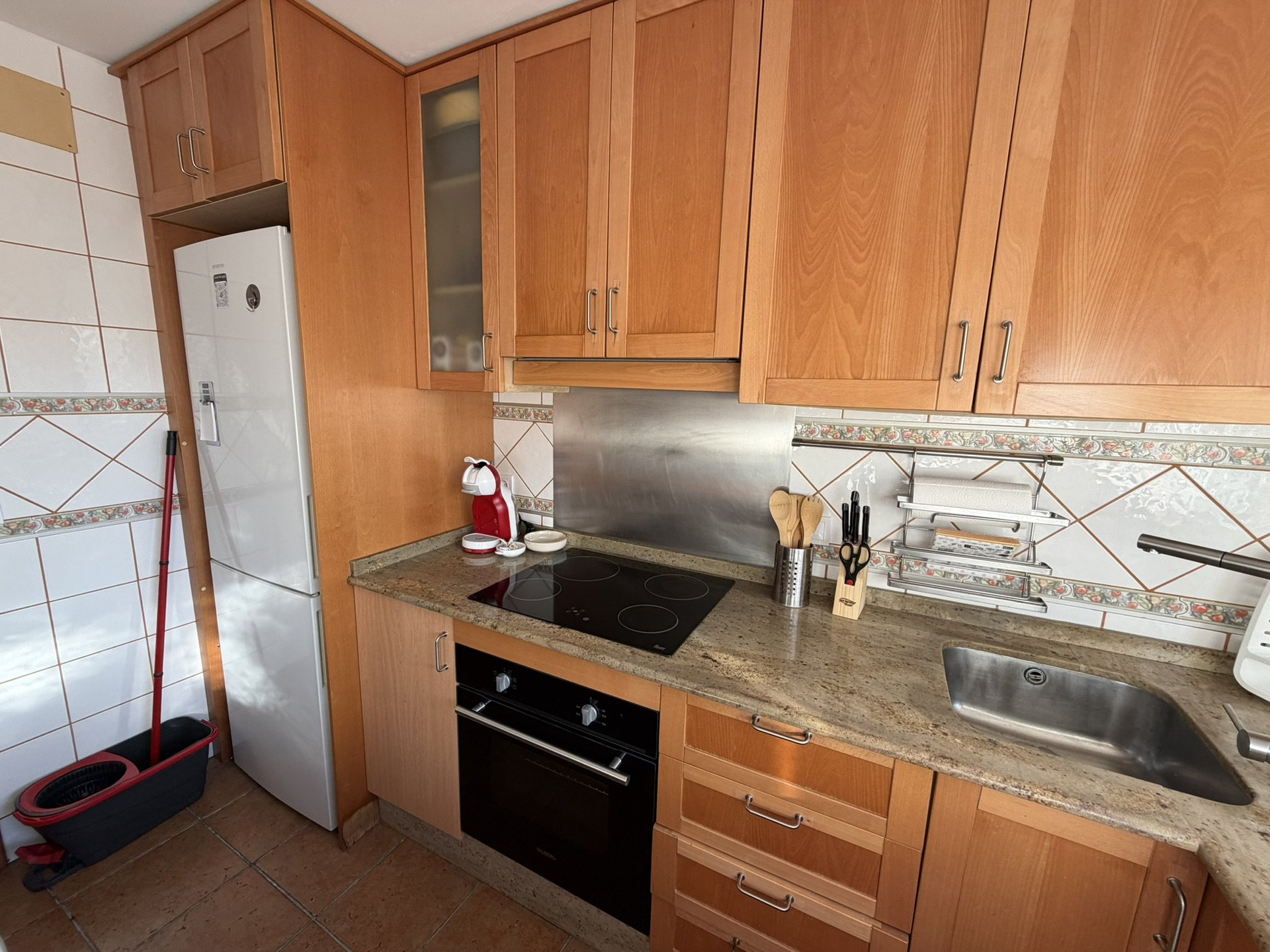 Kitchen counter with oven and fridge