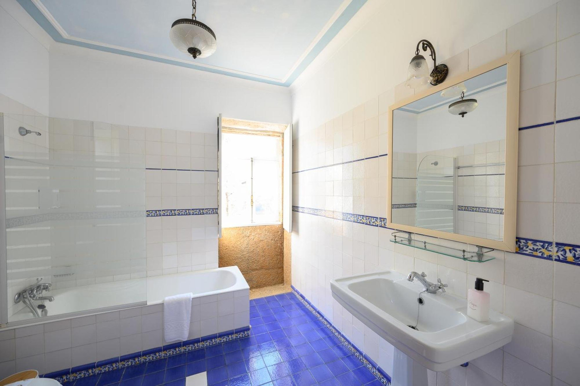 Bright blue tiled bathroom