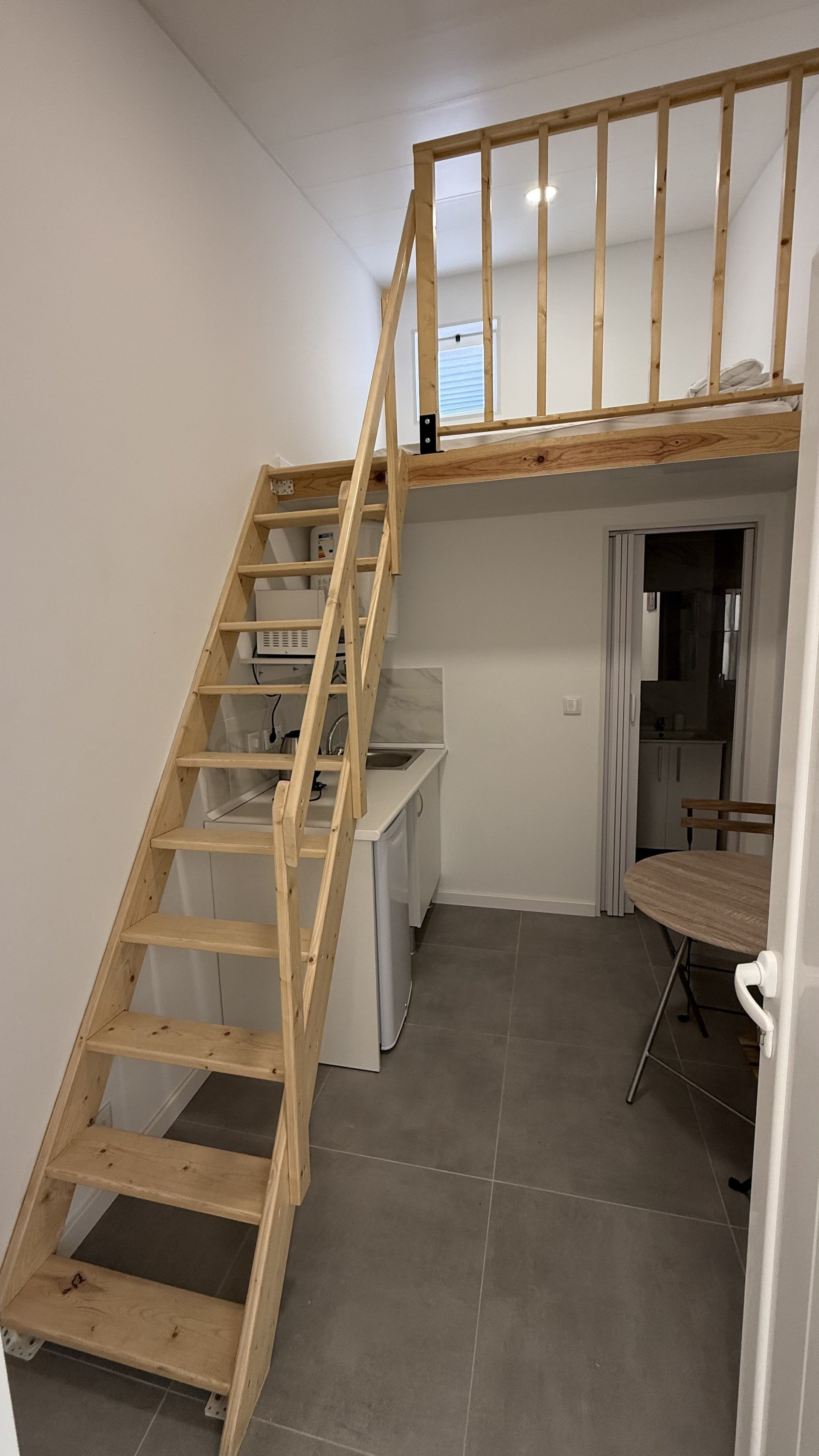 Studio view with kitchenette and loft