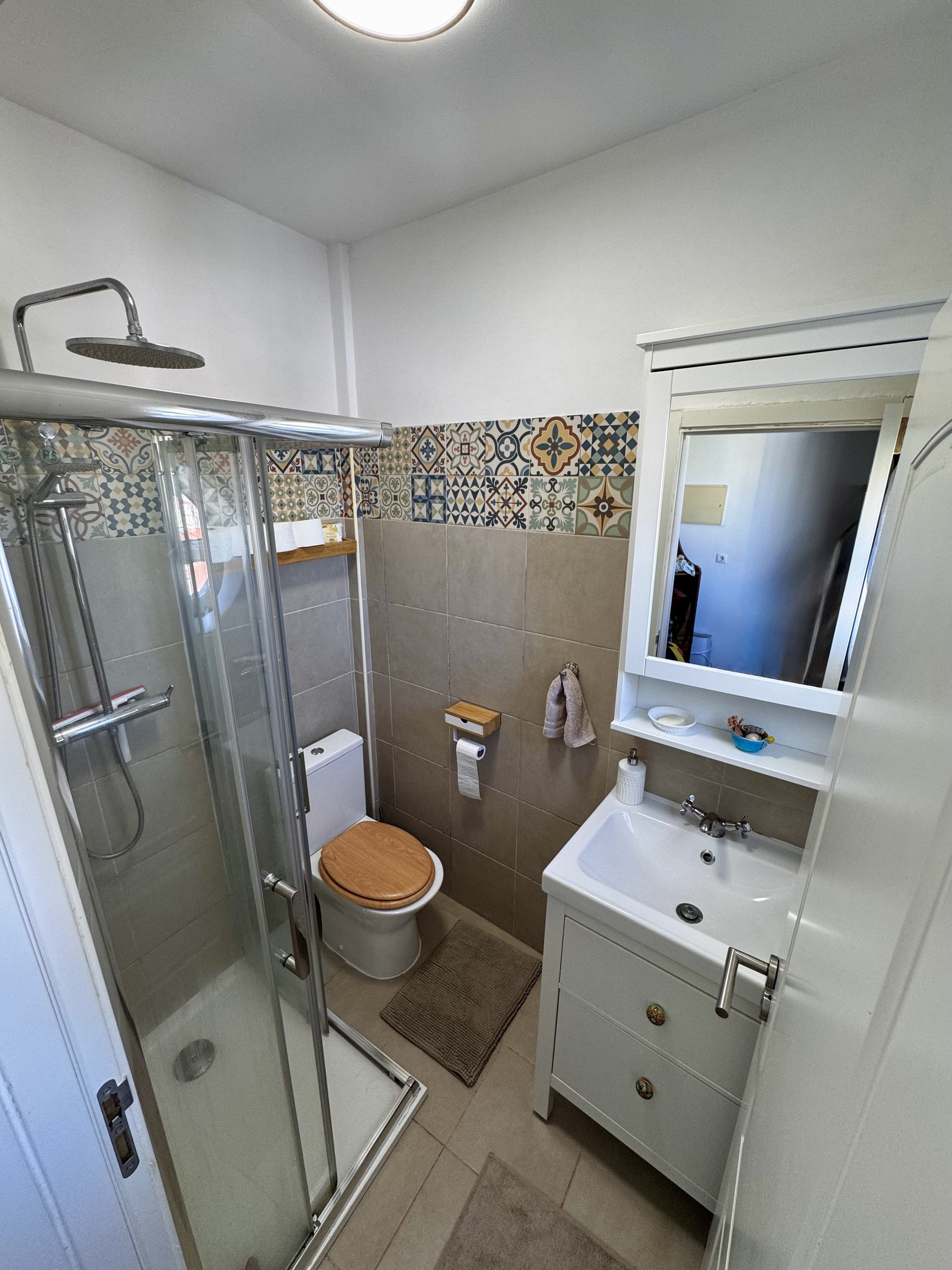 Bathroom with shower and tiled walls