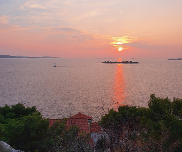 Sunset over island silhouette