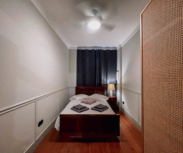 Bedroom seen through rattan wardrobe
