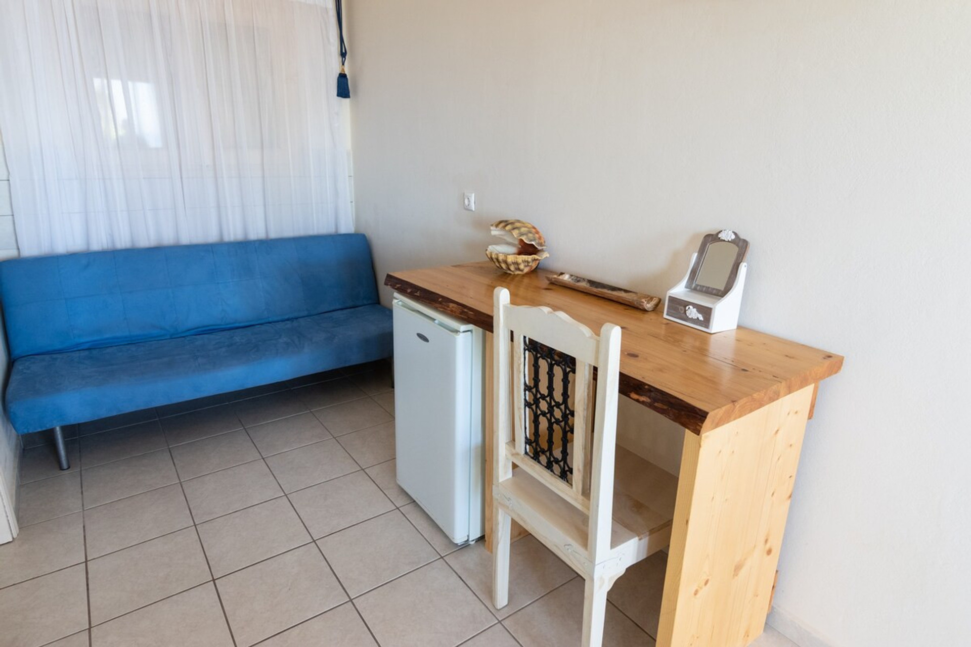 A double sofa bed, workplace, and refrigerator included