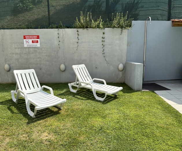 Garden loungers by outdoor shower
