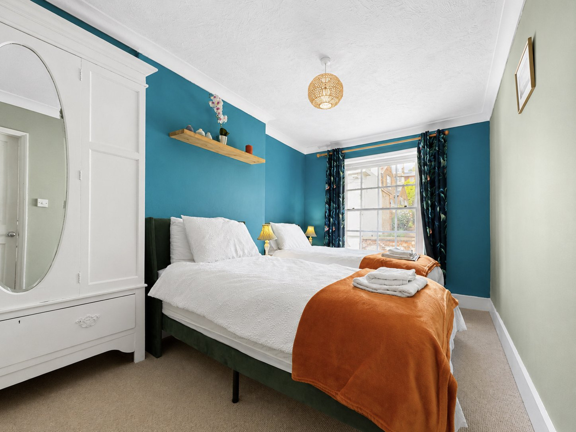 Twin bedroom with teal walls
