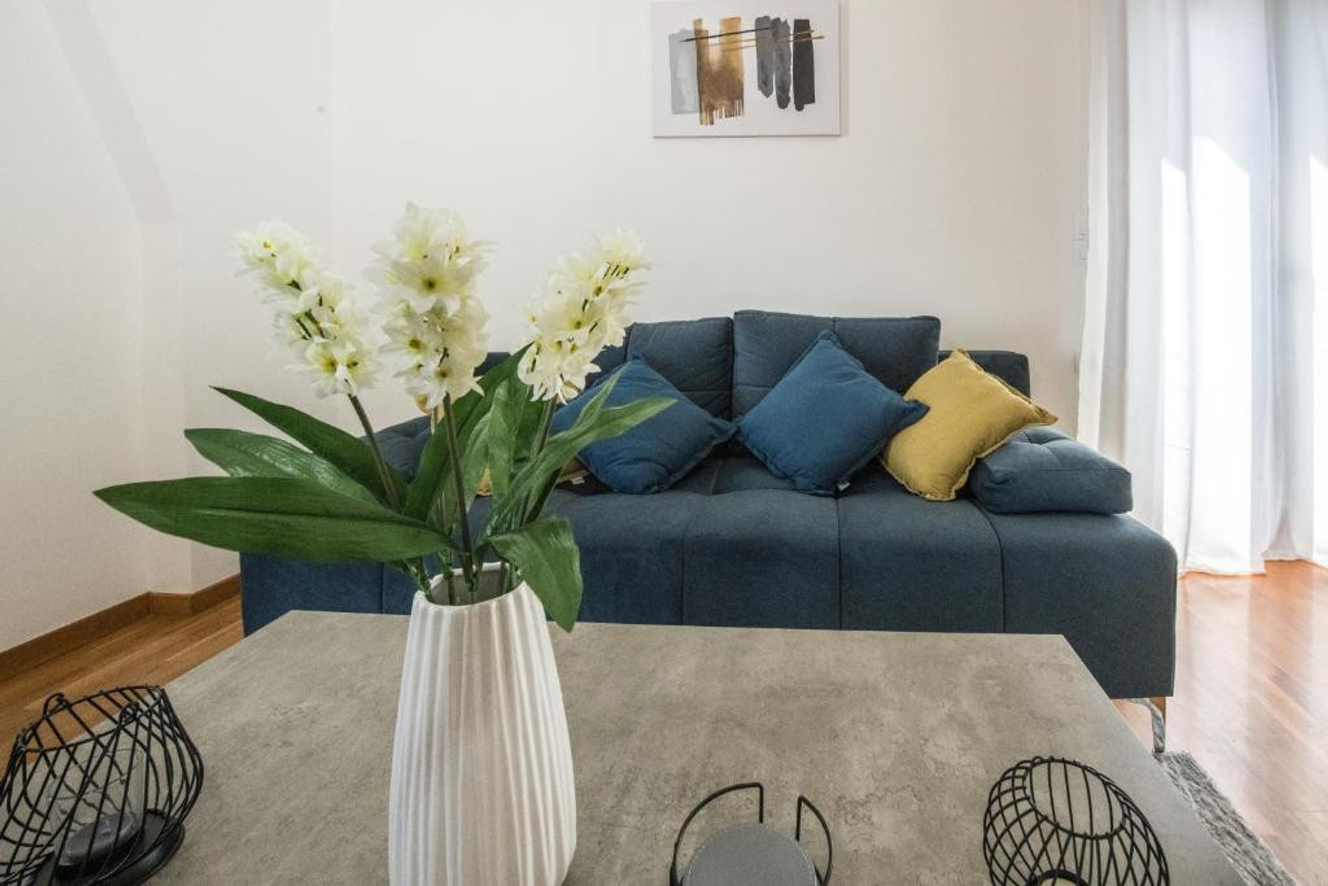 Blue sofa with colorful cushions