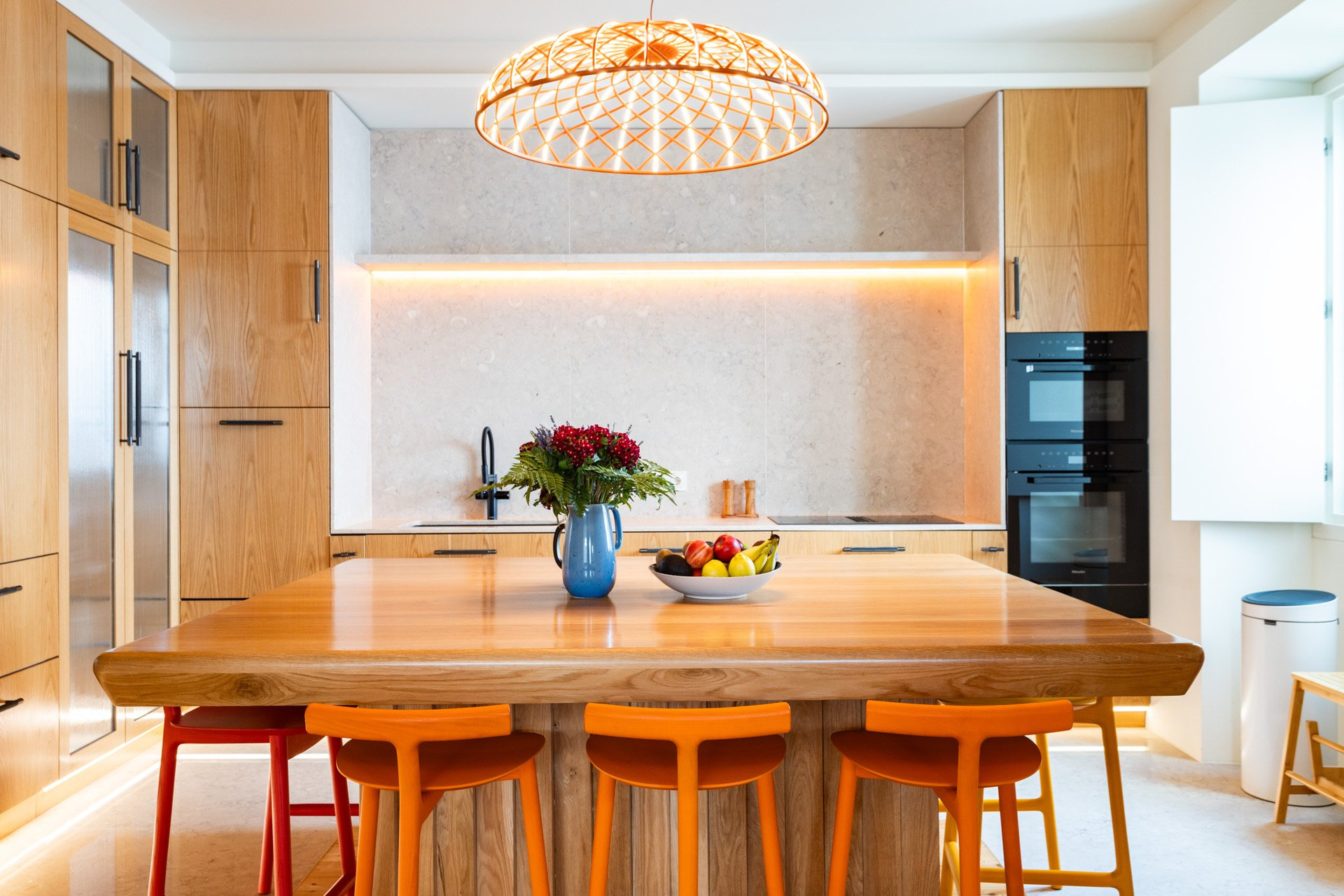 Kitchen island with orange stools