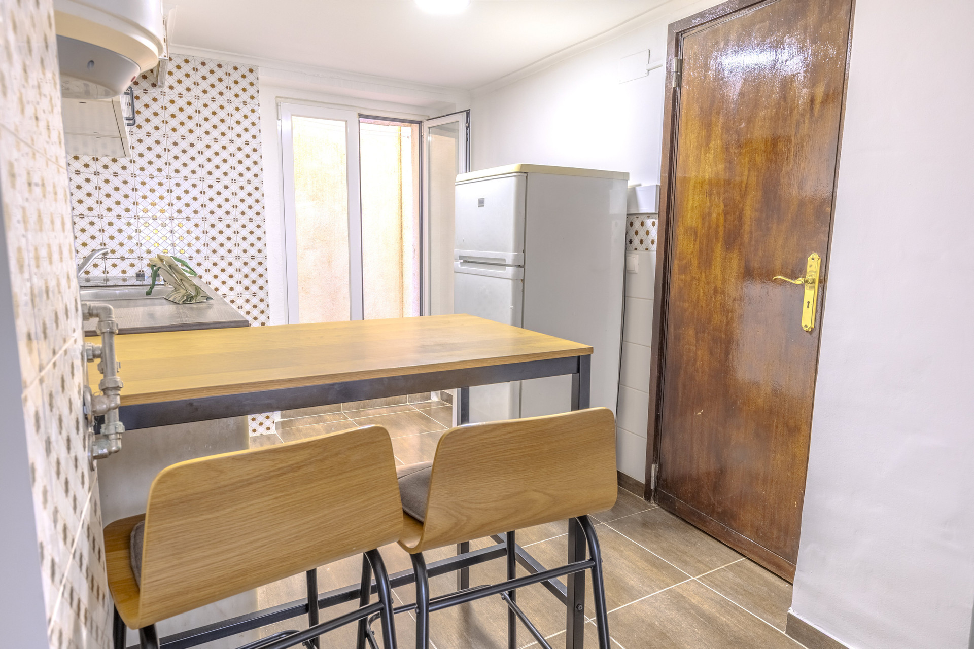 Kitchen with dining table and fridge