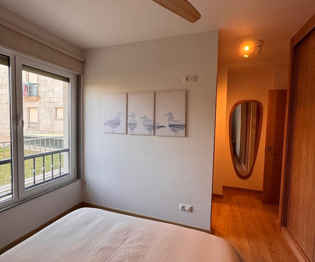Bedroom with hallway and mirror