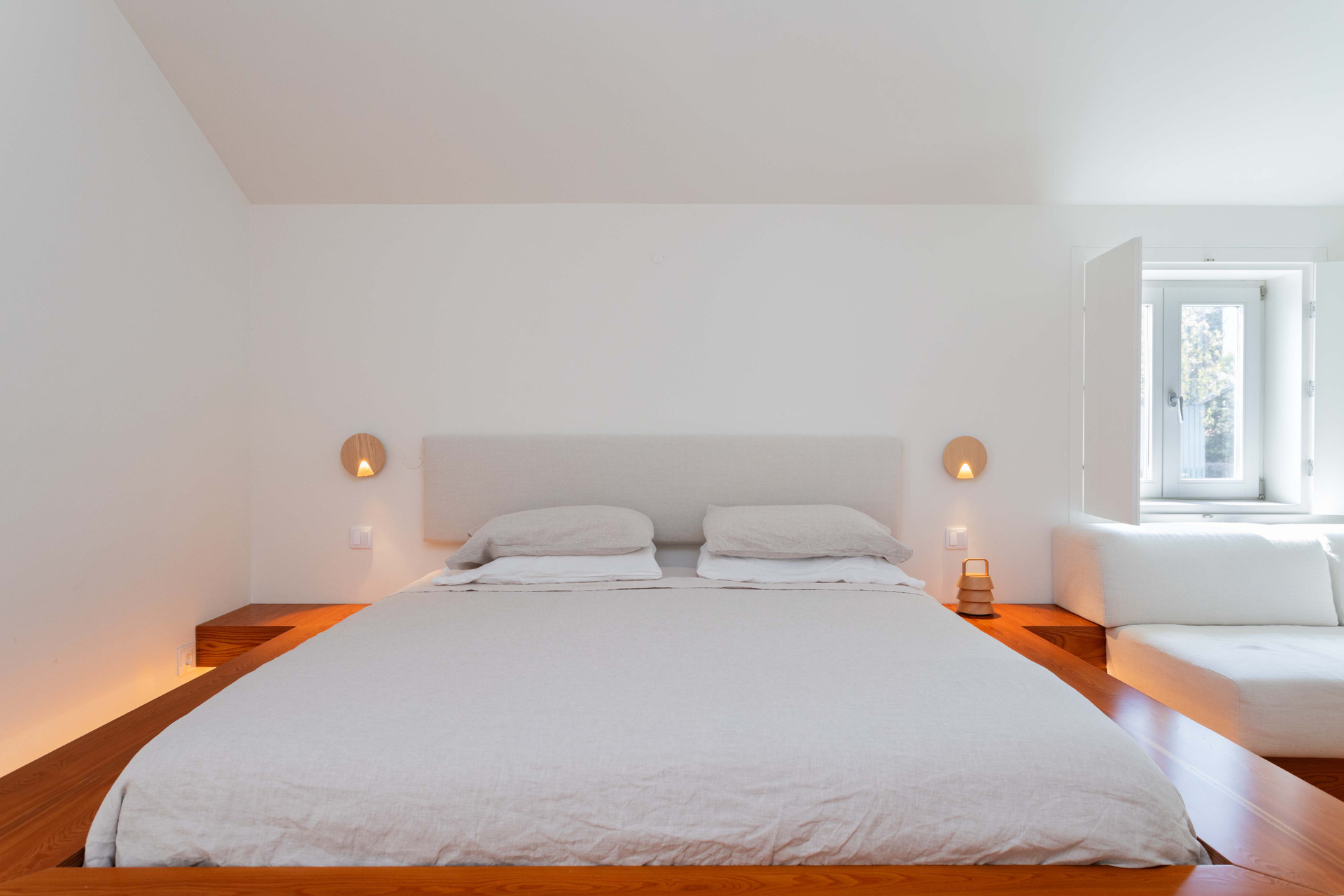 Minimalist white platform bedroom