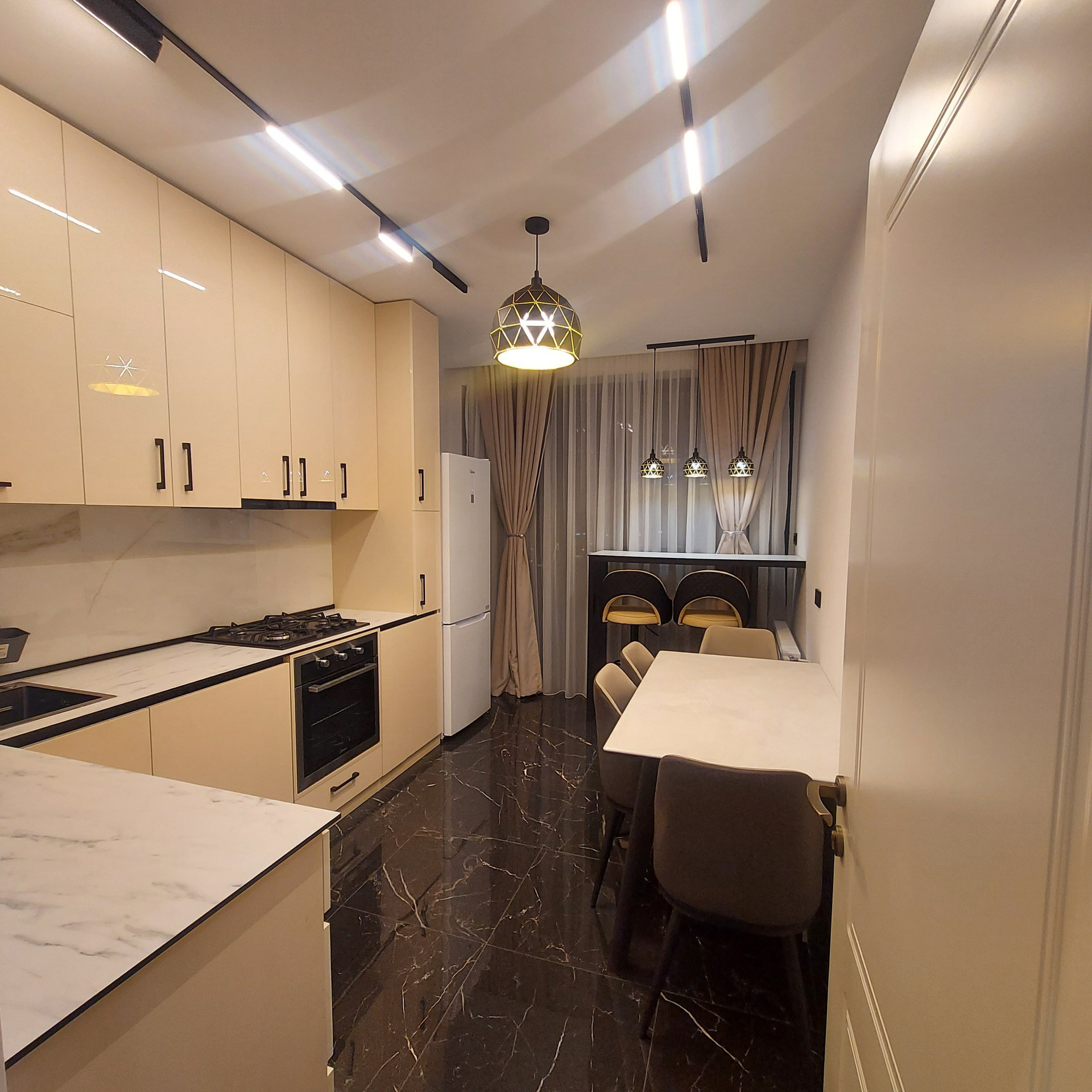Kitchen with dark marble and dining nook