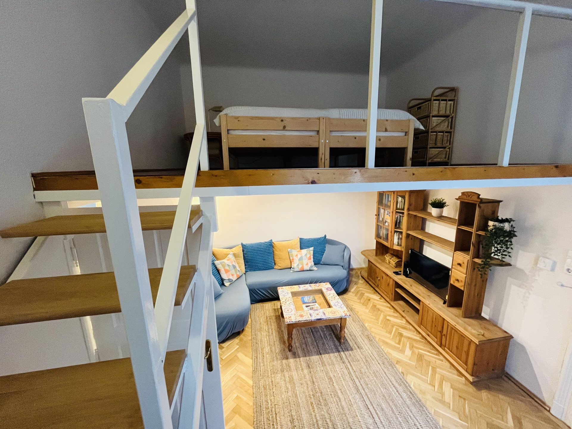 Loft living room with mezzanine bed