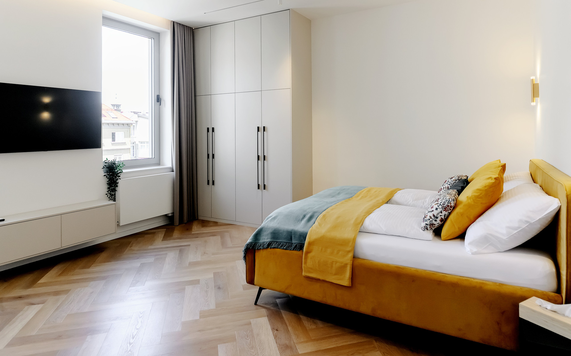 Spacious bedroom with wardrobe and TV