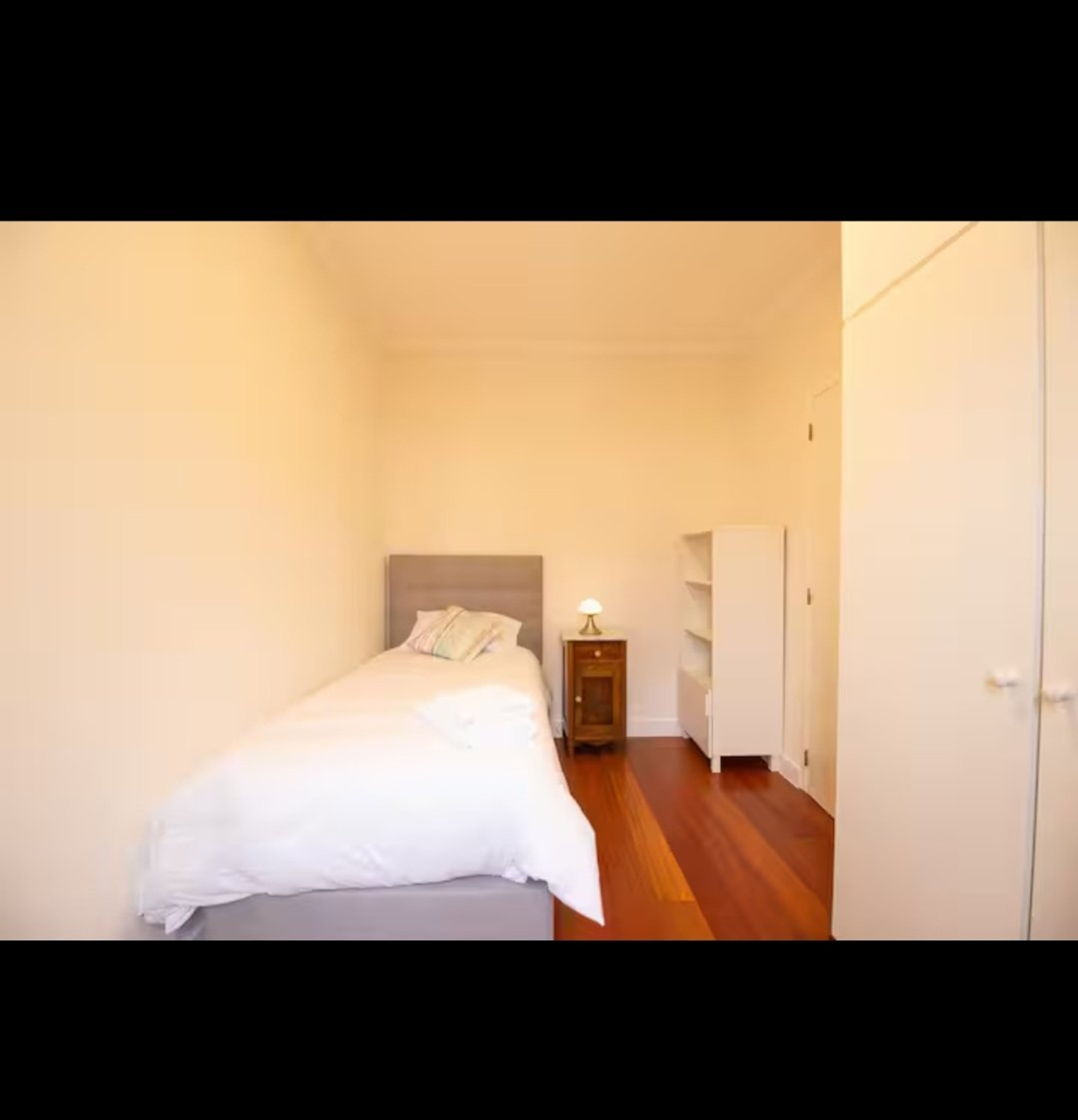 Single bedroom with bookshelf