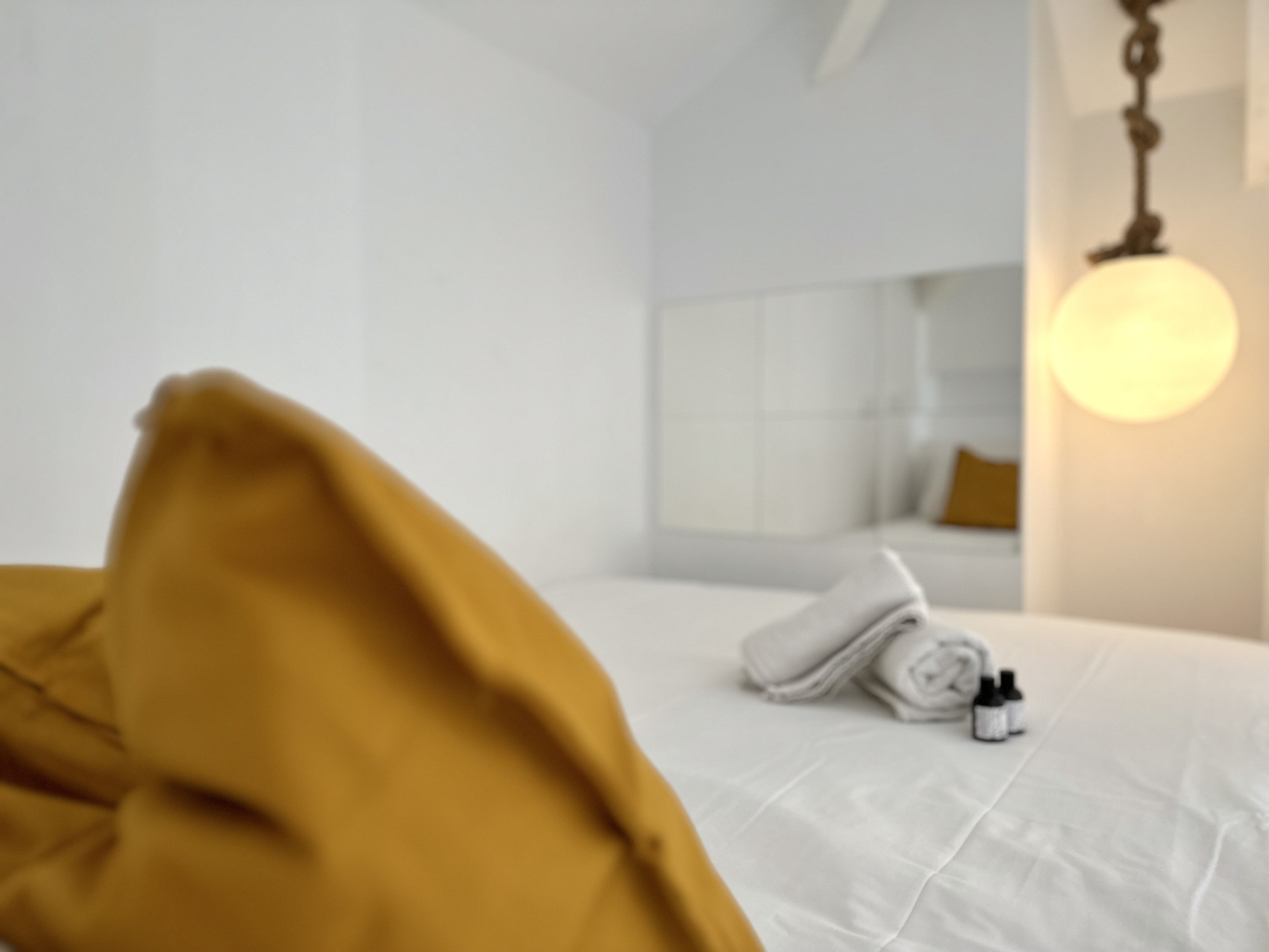 Bedroom bed with towels lamp