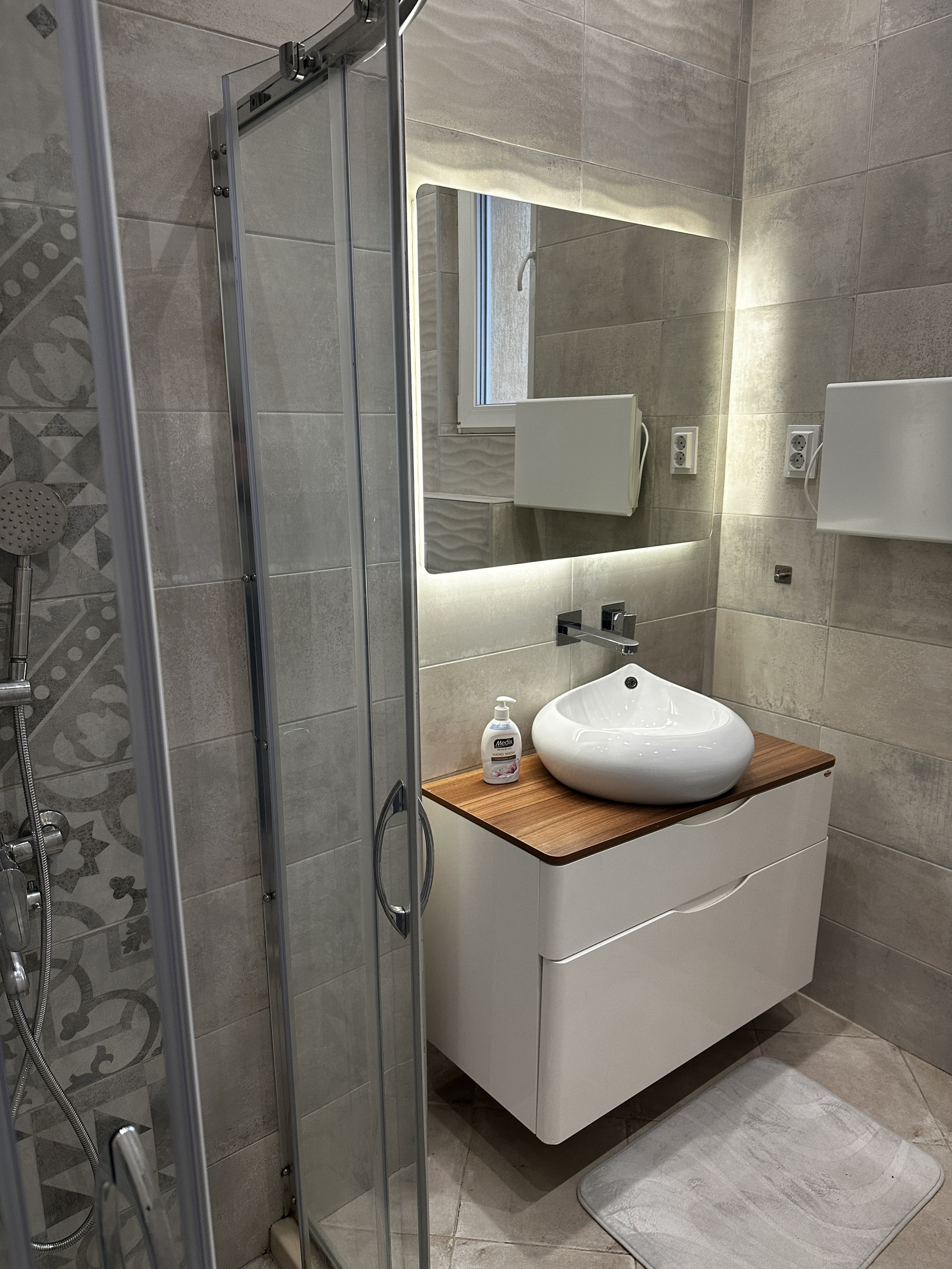 Bathroom vanity with backlit mirror