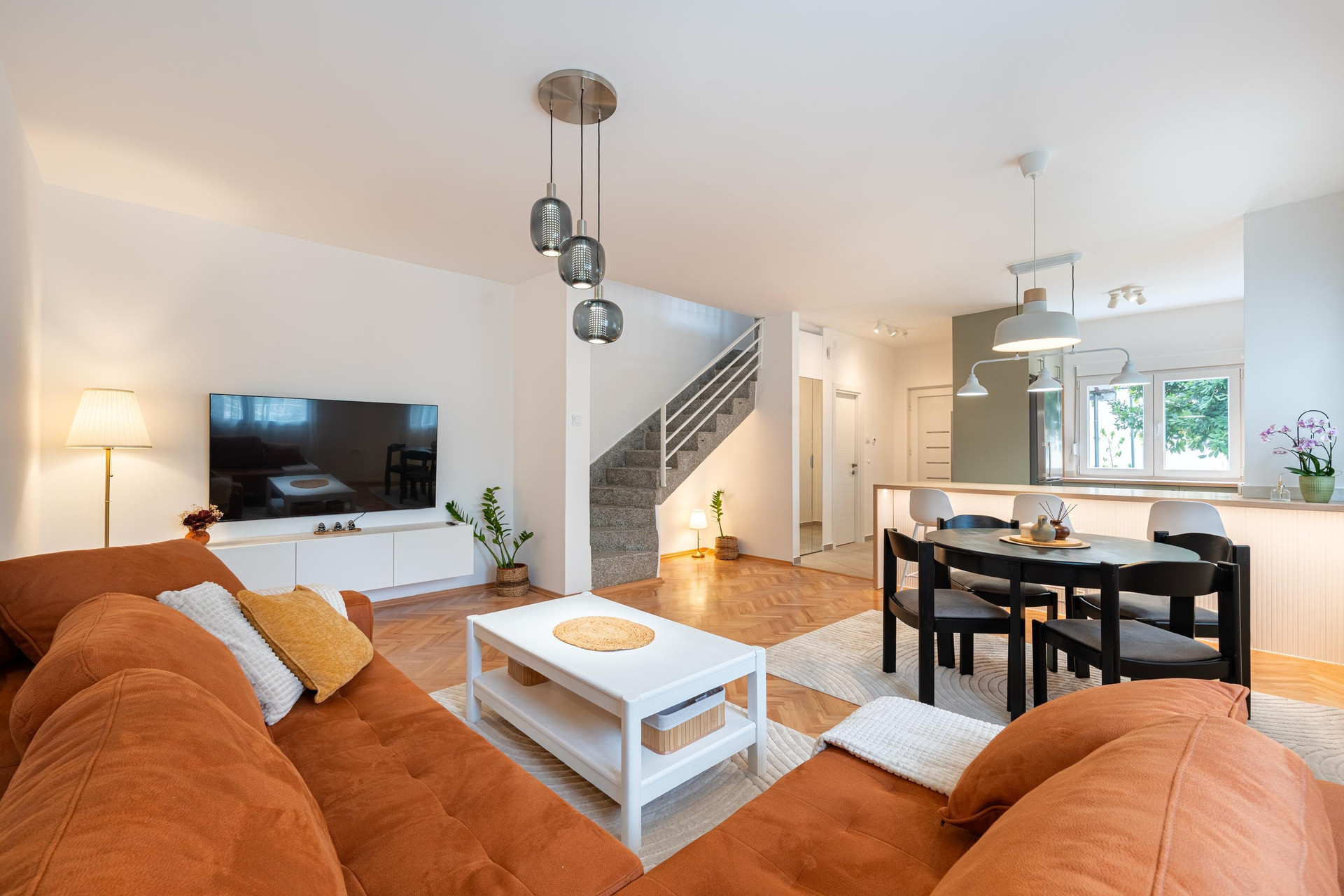 Living room with staircase and dining