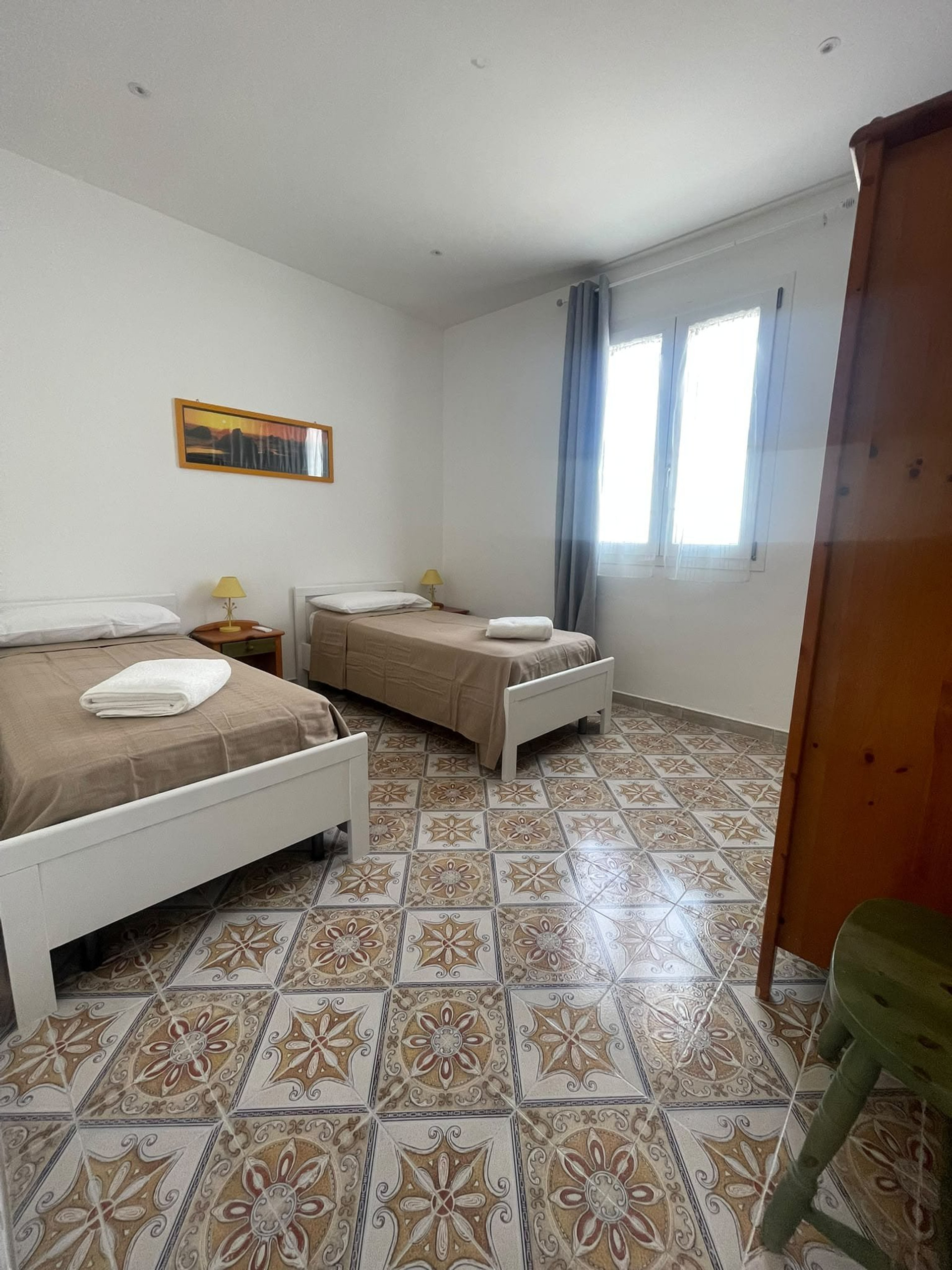 Twin bedroom with patterned floor