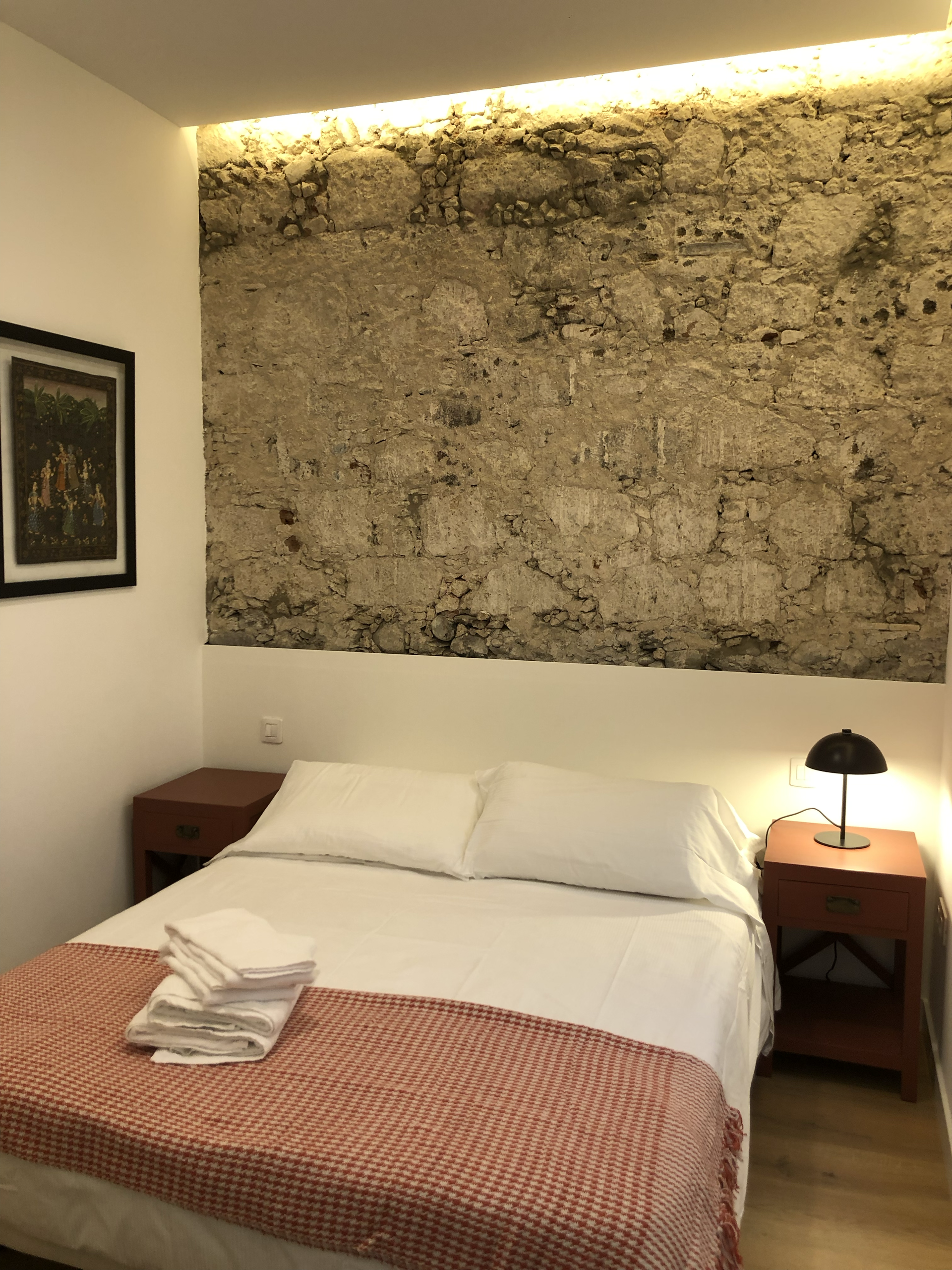Bedroom with stone wall accent