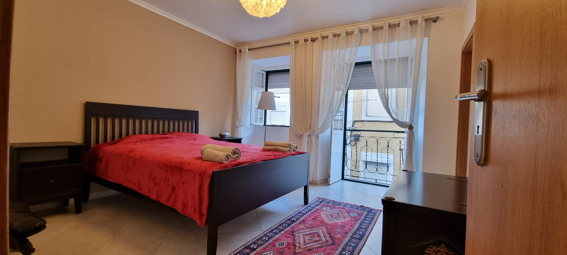 The main double bedroom with a balcony and storage closet