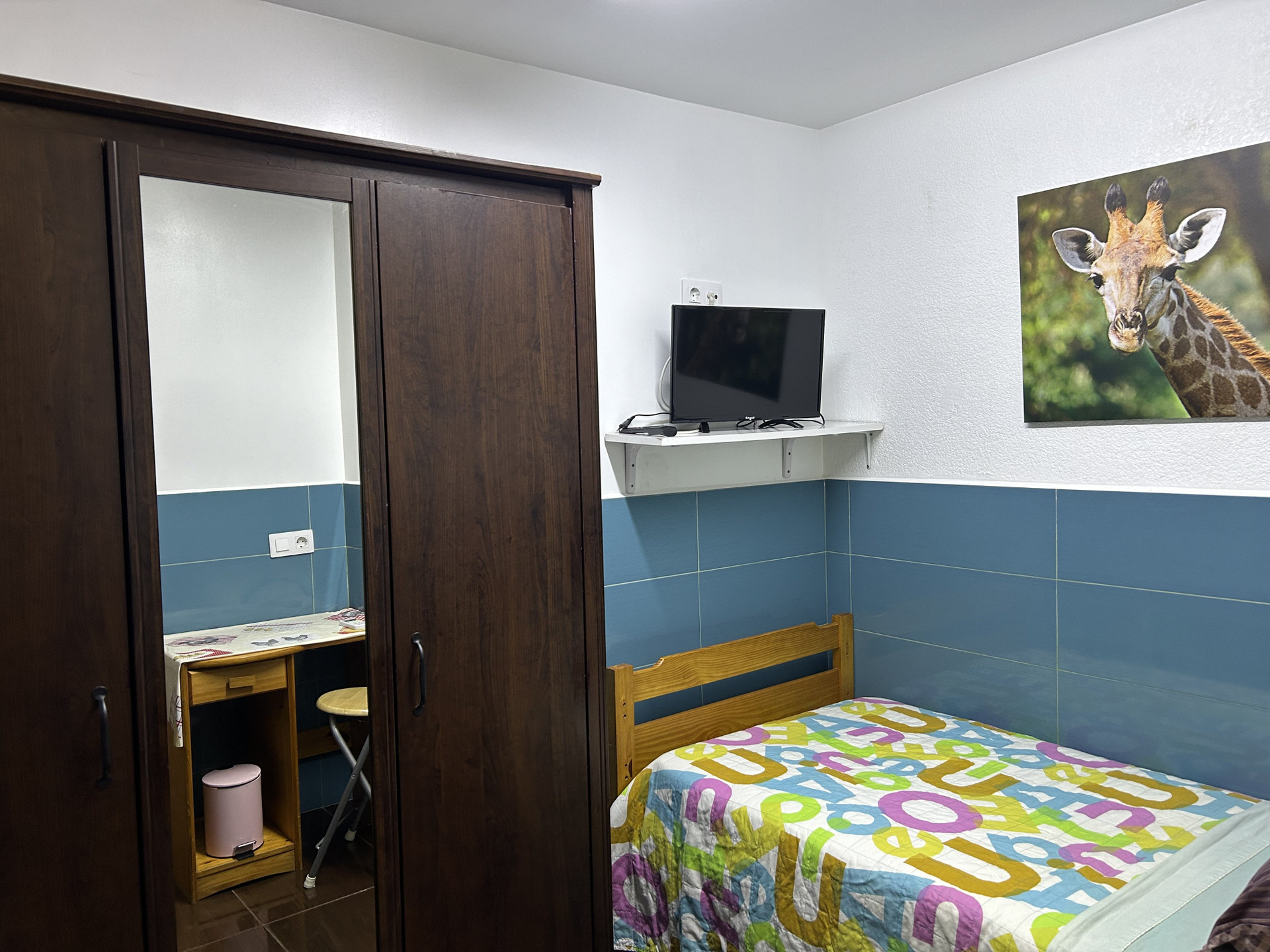 Bedroom with wardrobe TV and bed