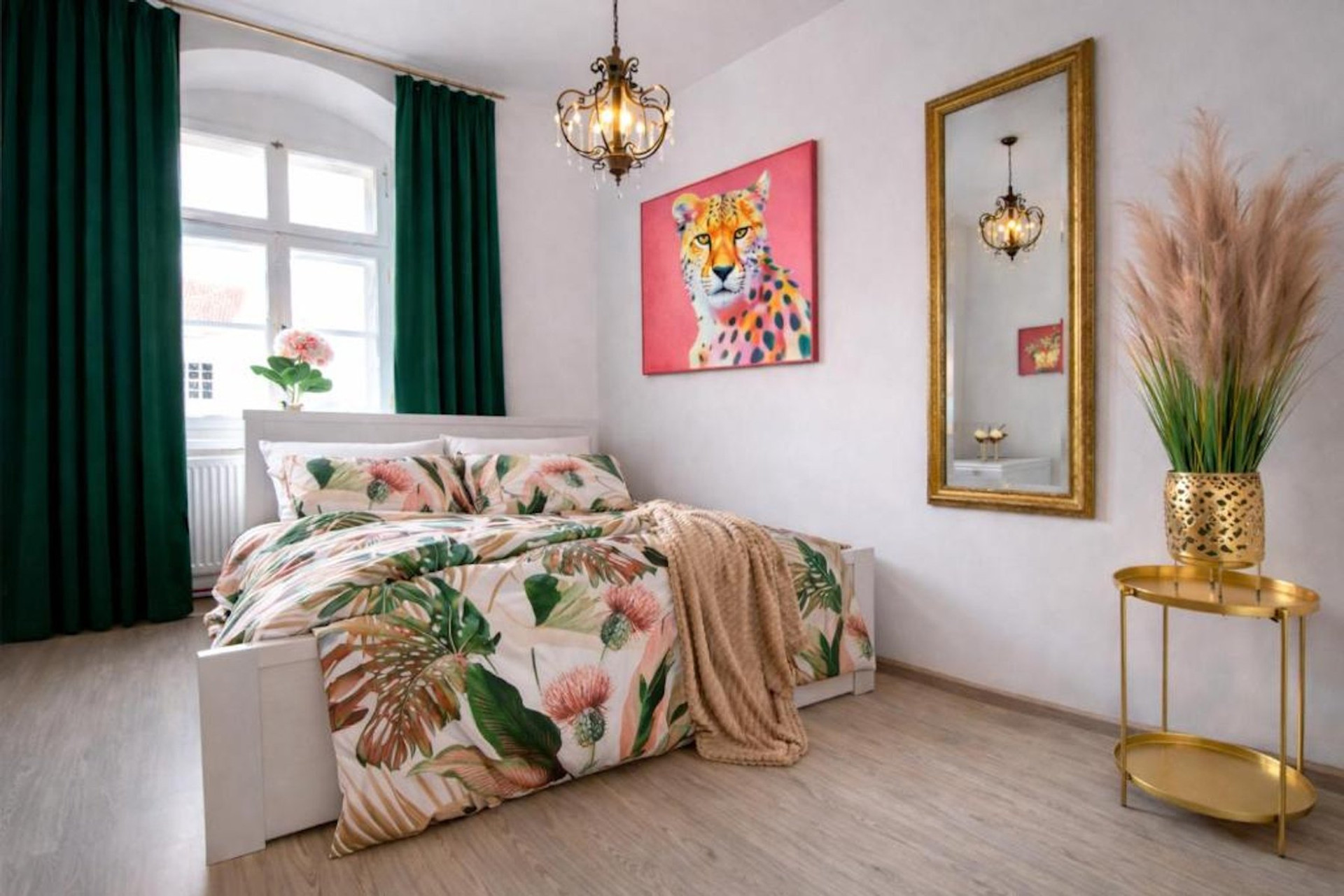 Bedroom with floral bedding and mirror