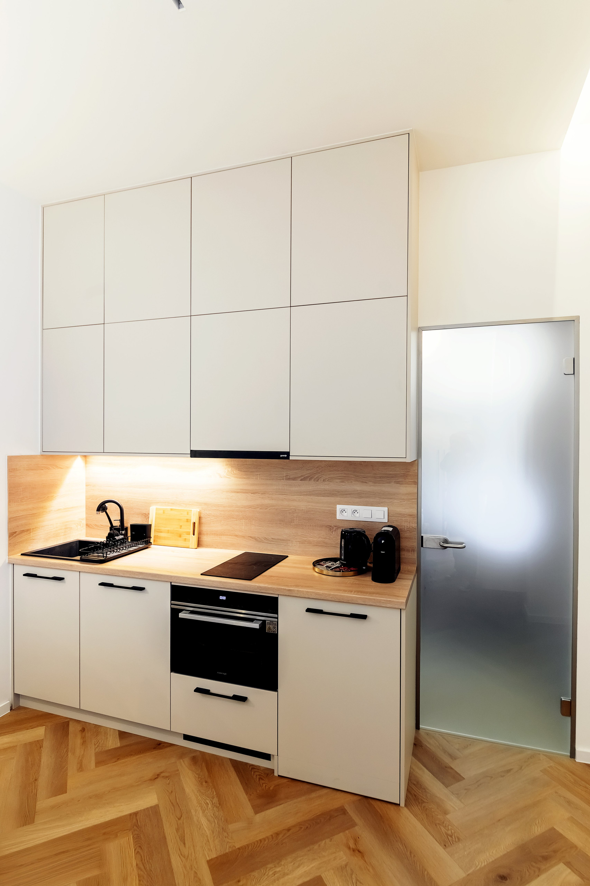 Modern kitchenette with oven and cabinets