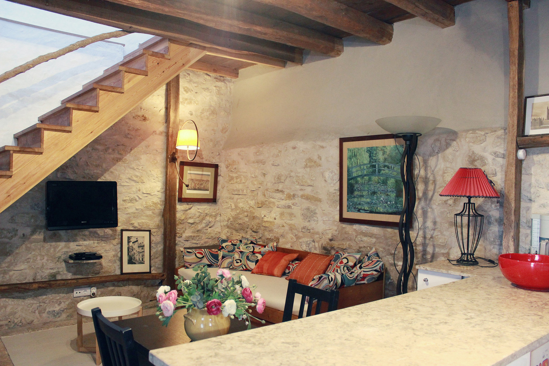 Rustic living room with stone walls staircase