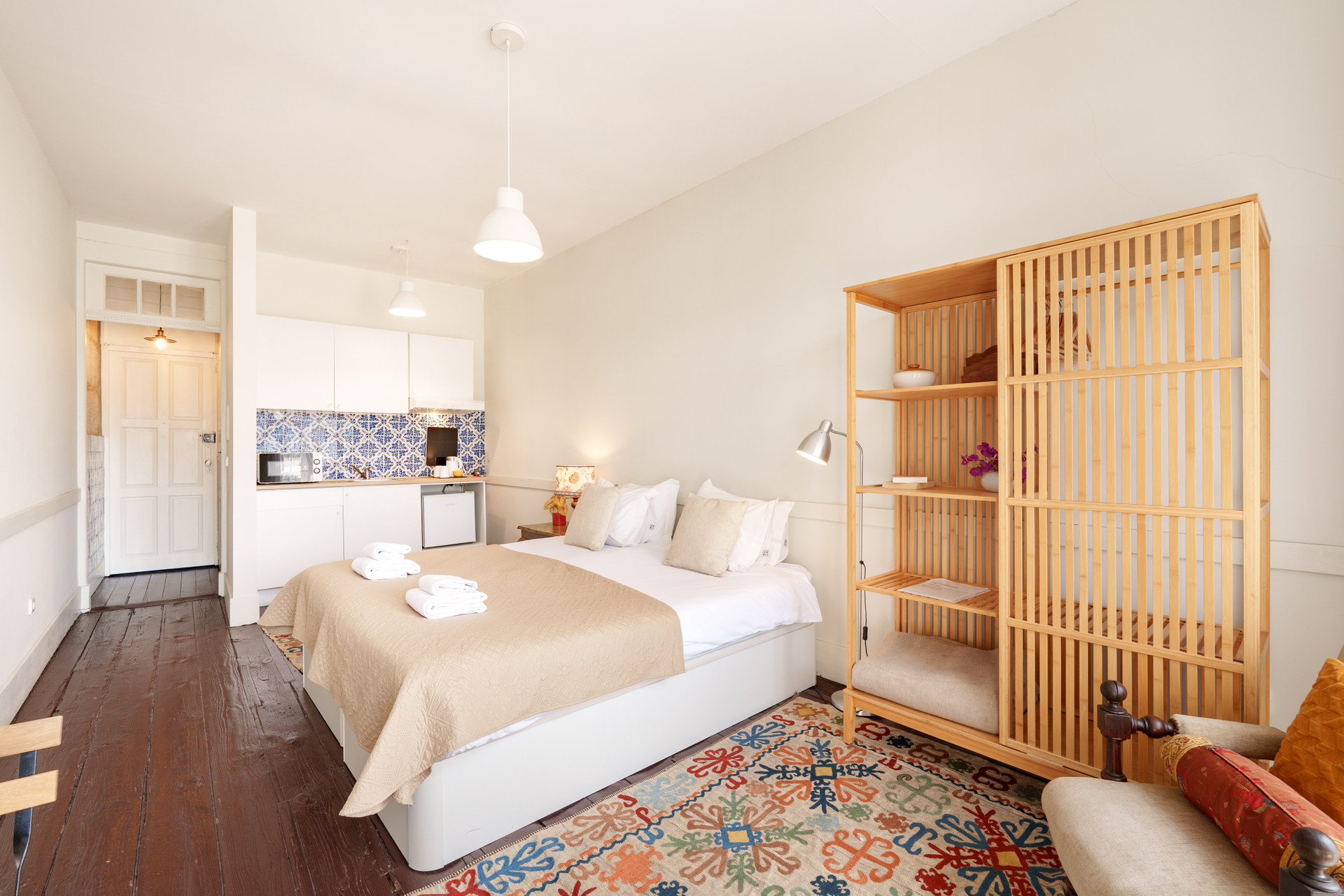 Studio bedroom with kitchenette wooden shelving