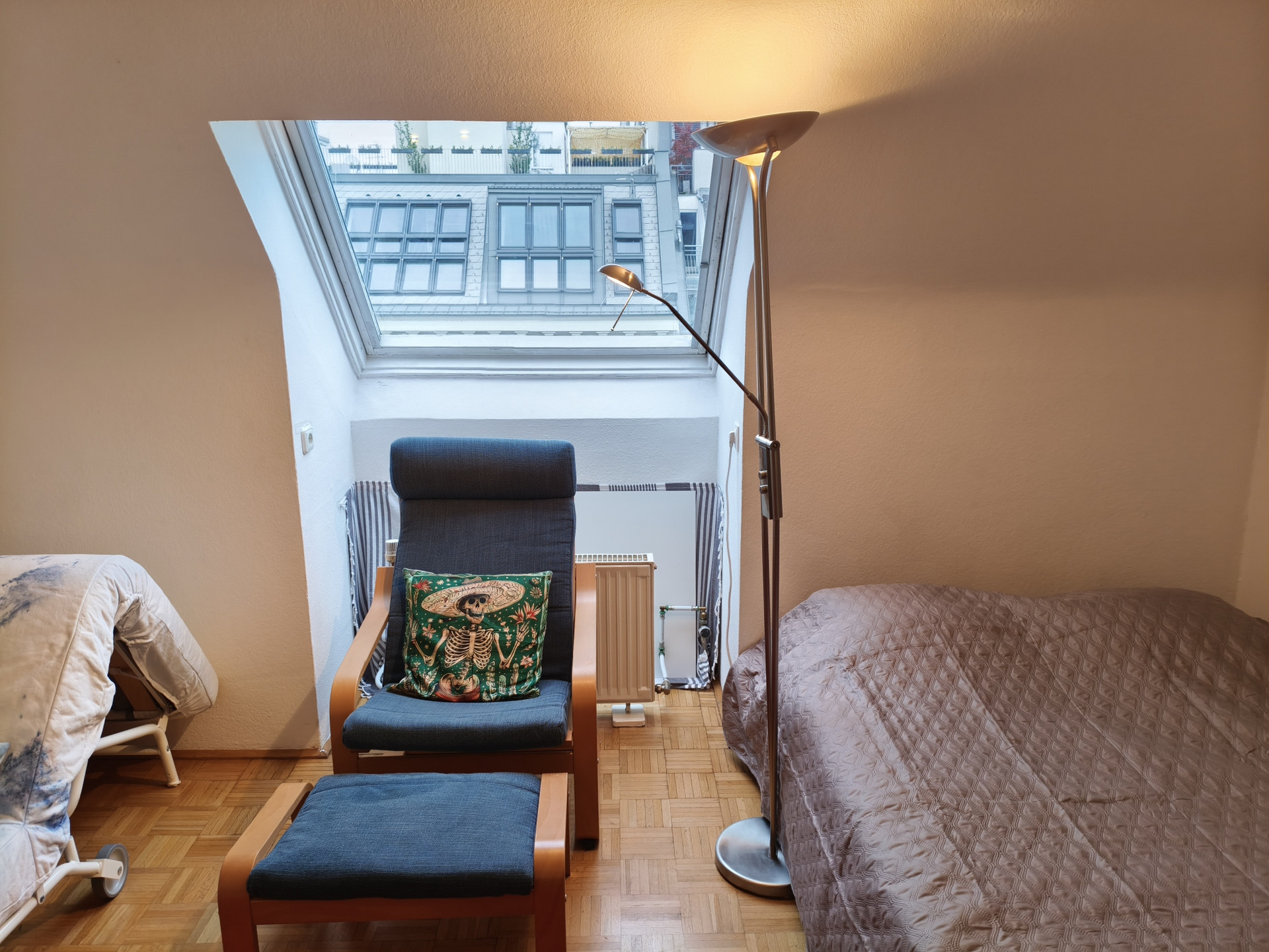 Bedroom with skylight and chair