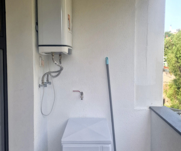 Balcony utility area with water heater