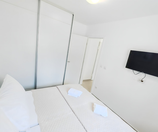Bedroom with wardrobe and TV