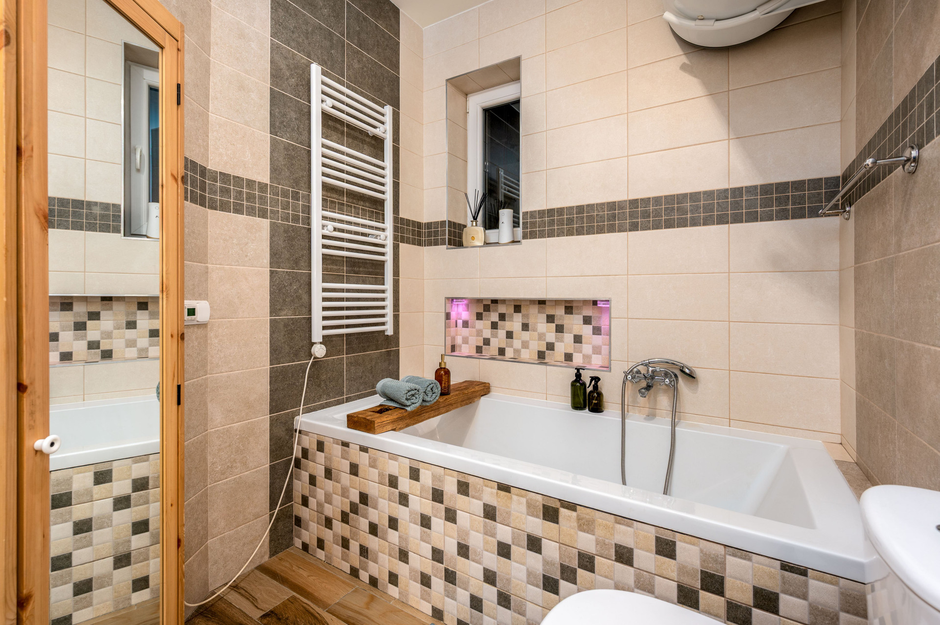Bathroom with tub mosaic tiles