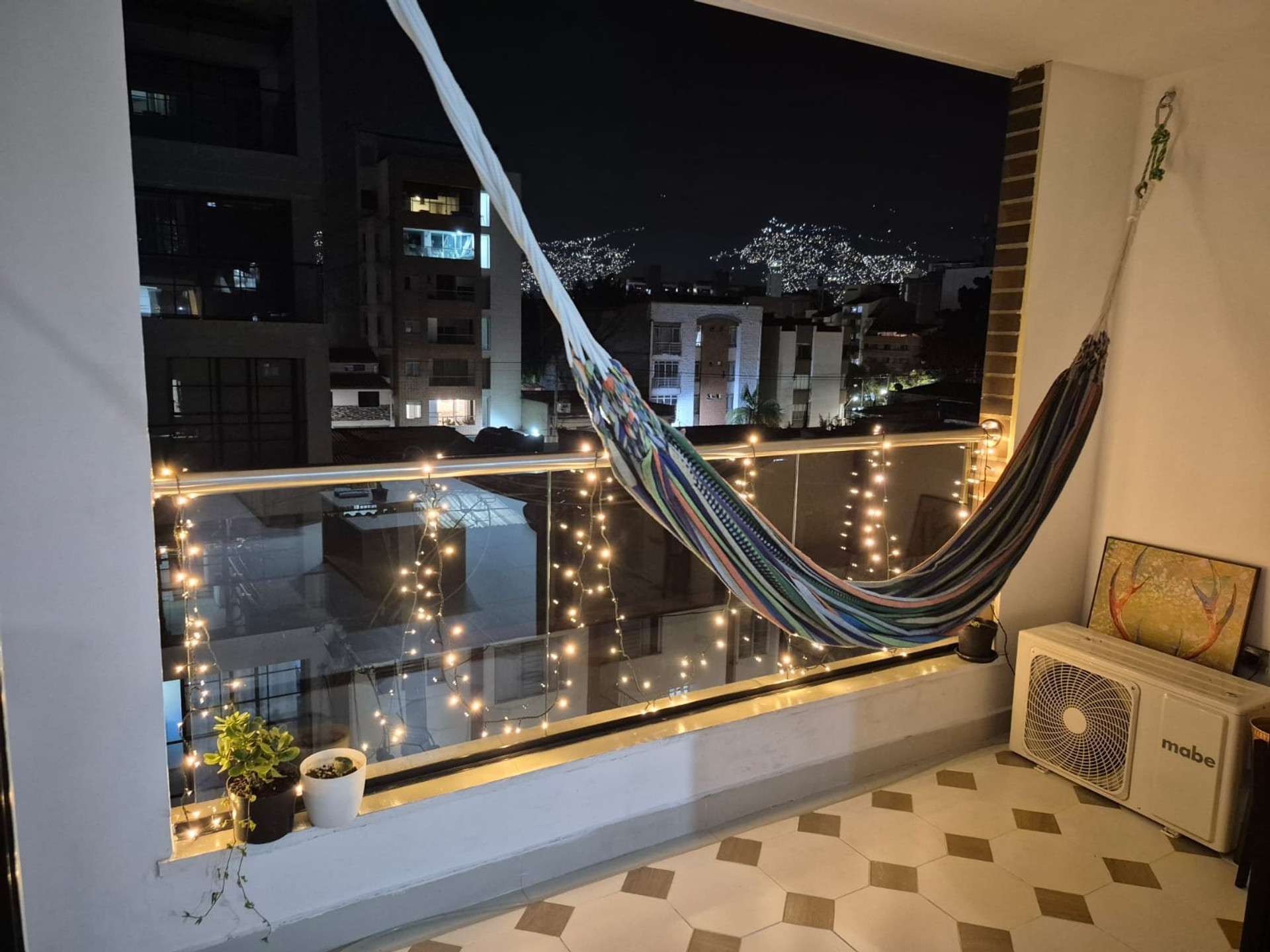 Balcony hammock with city night view