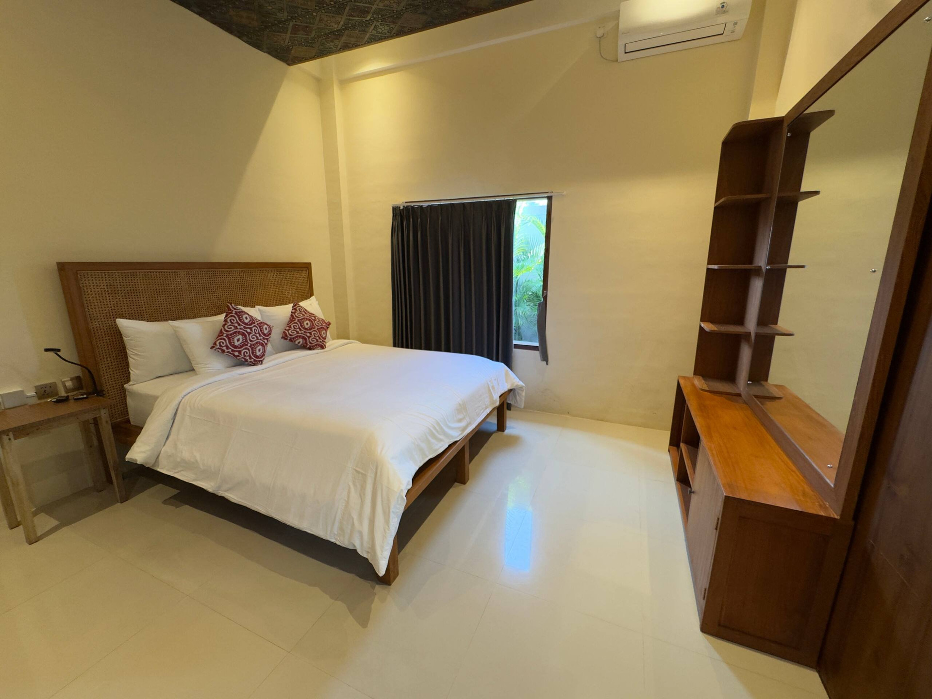 Bedroom with rattan headboard and dresser