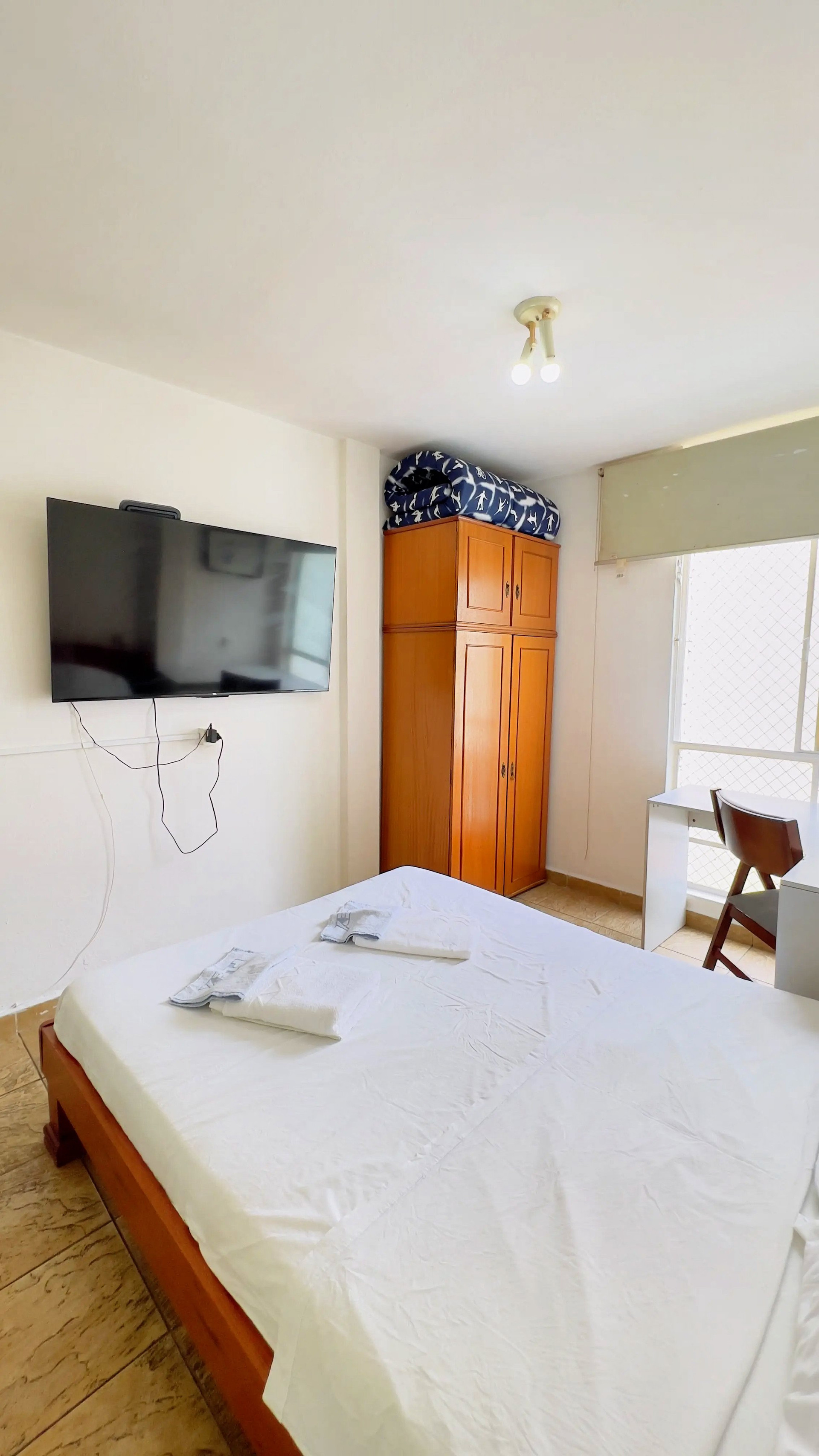 Bedroom with TV and wardrobe