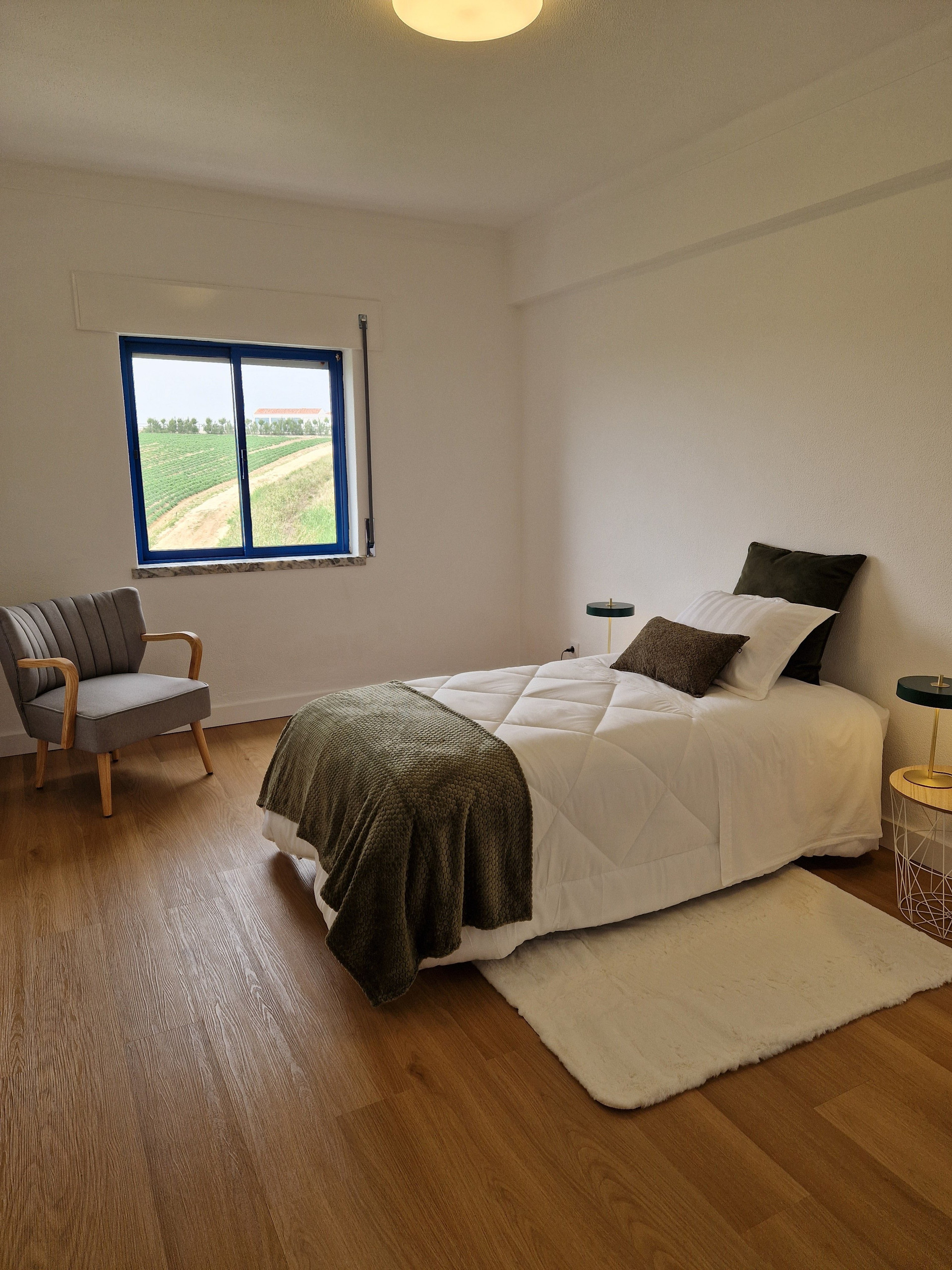 Single bedroom with armchair, view