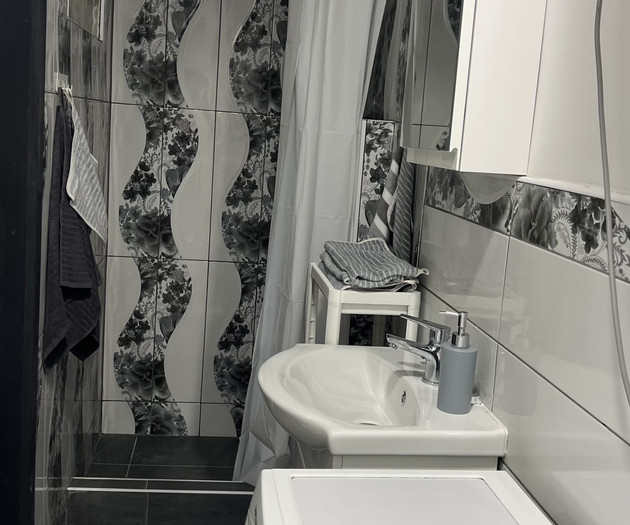 Bathroom with shower and sink