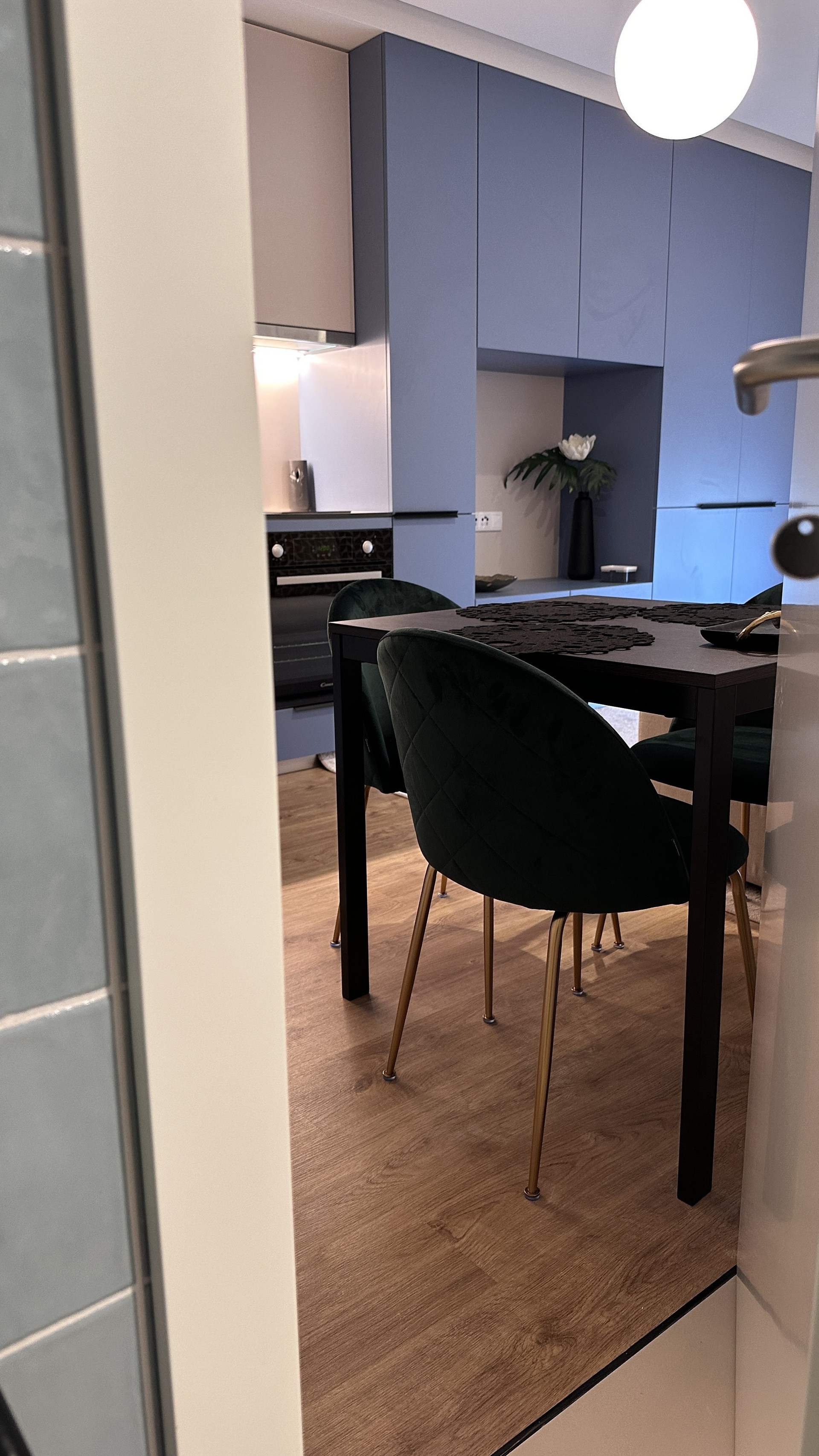 Dining table and blue kitchen