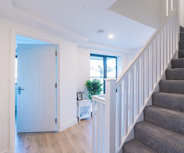 Landing with carpeted staircase