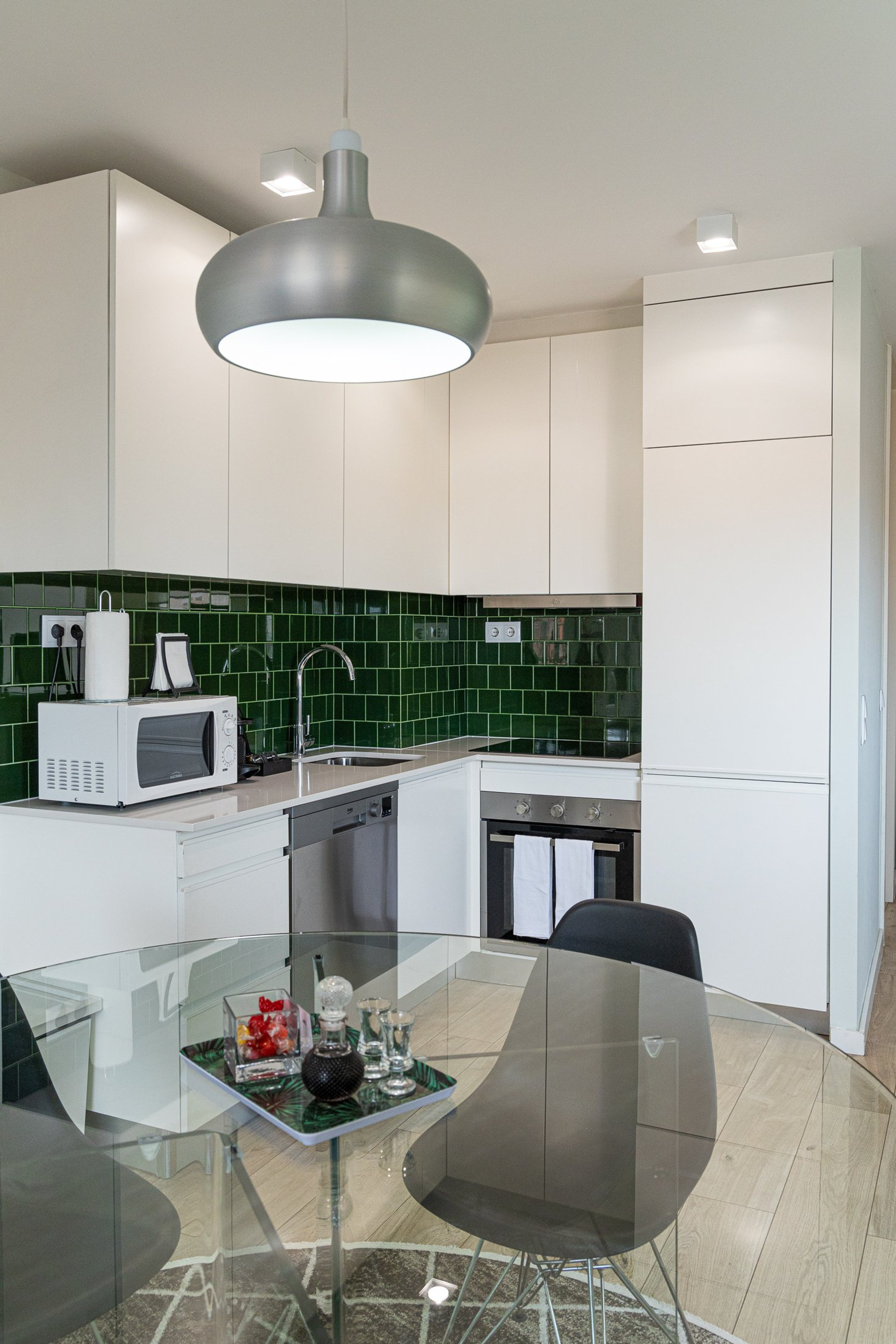 Kitchen with green tiled backsplash