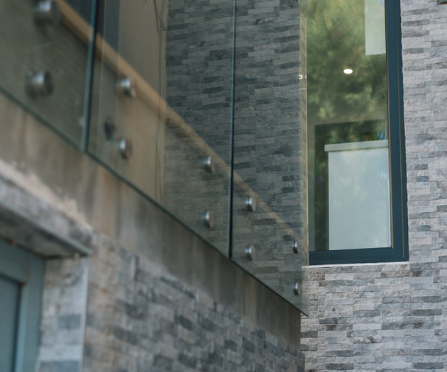 Stone facade with glass railing
