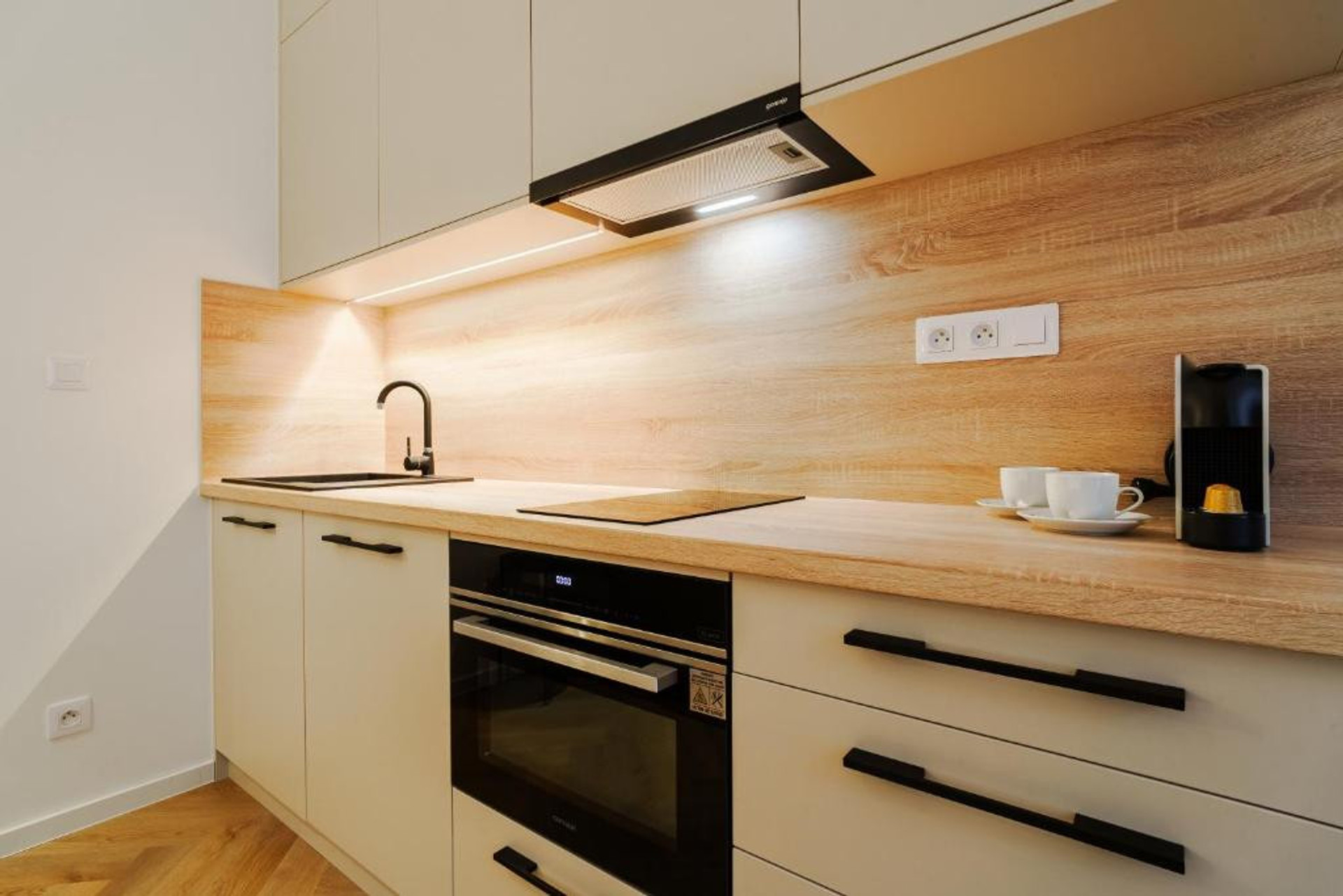 Modern kitchen with wood backsplash