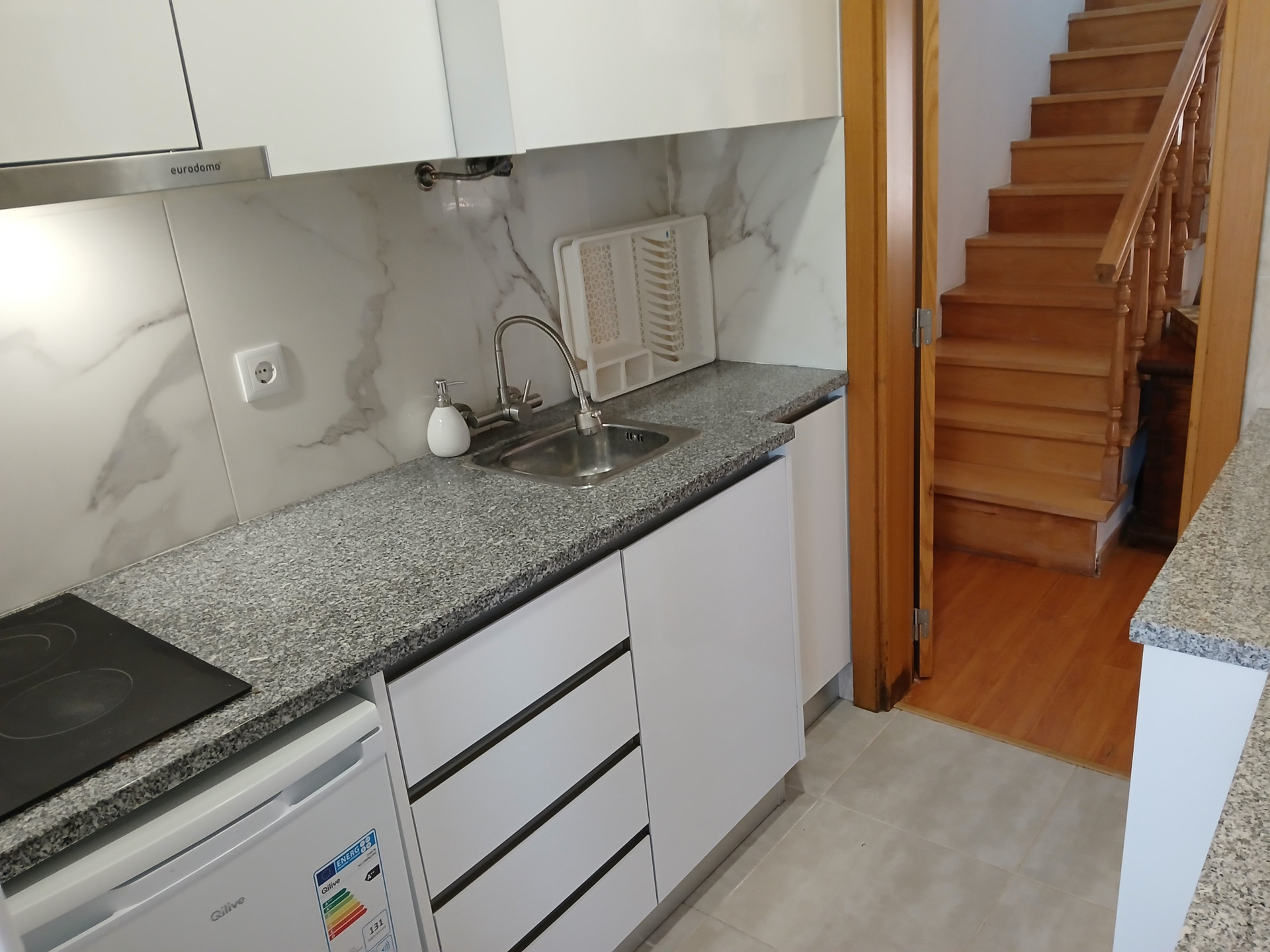 Kitchen counter sink and staircase