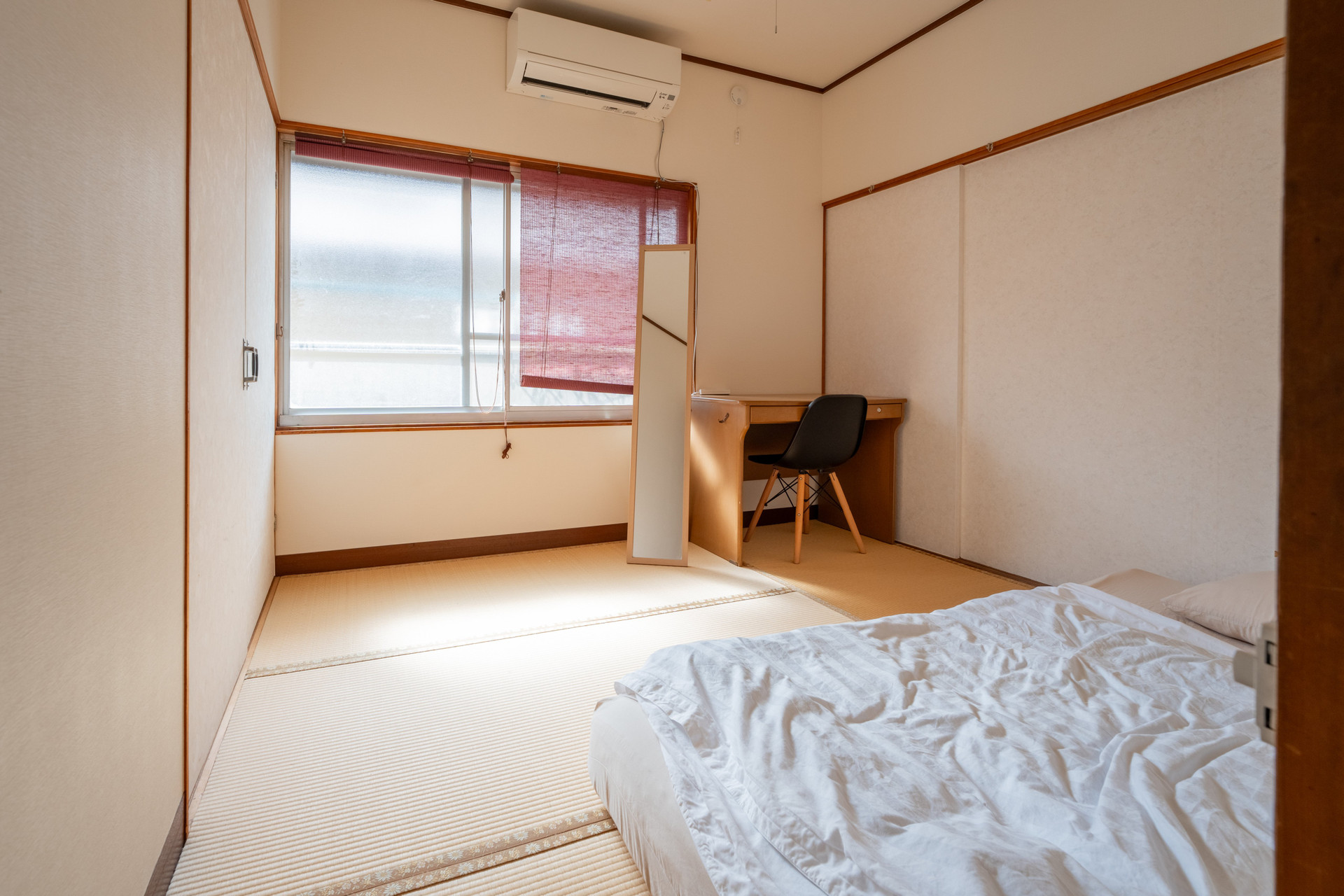 Bright bedroom with desk and mirror
