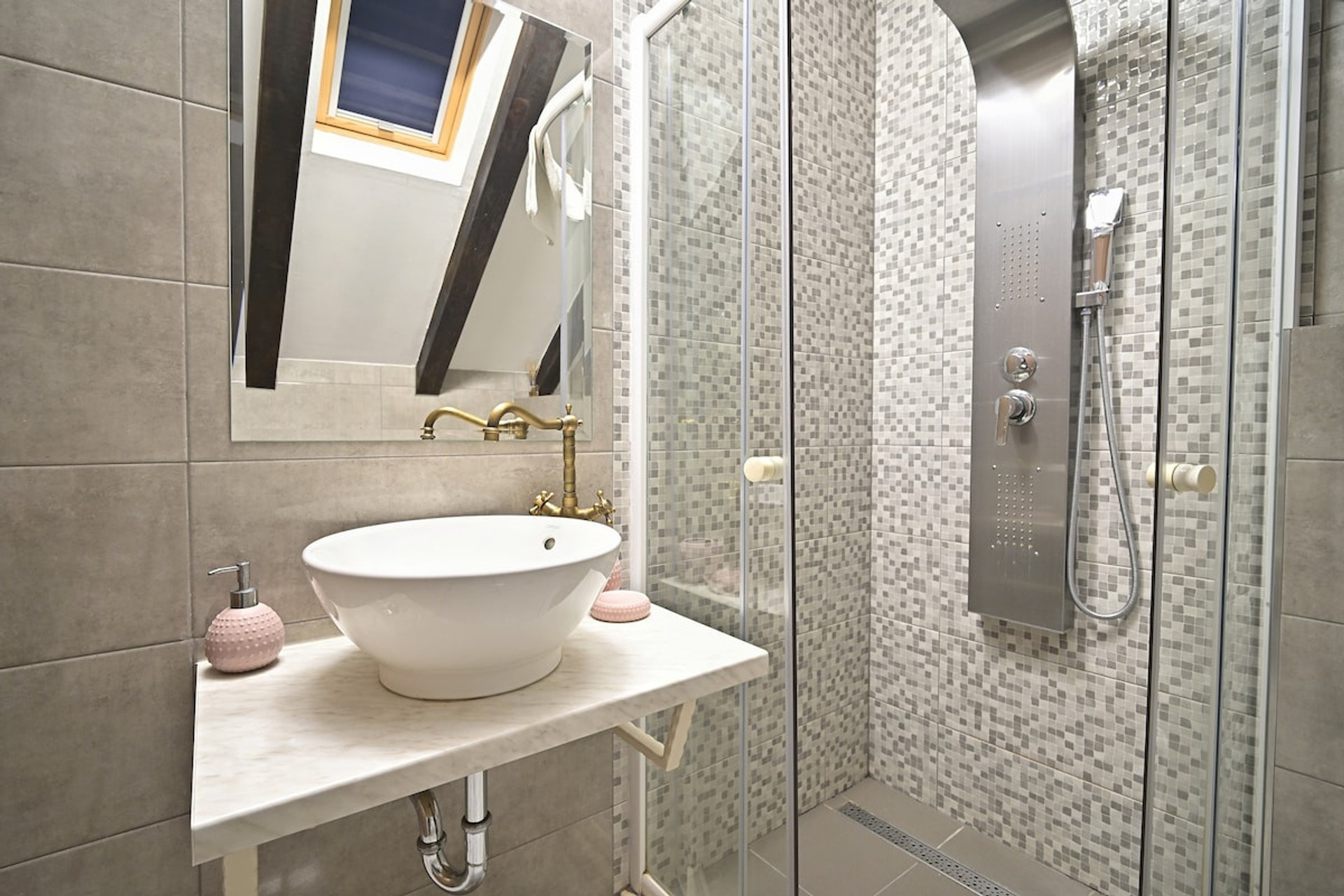 The bathroom features a sink, shower, and mirror.