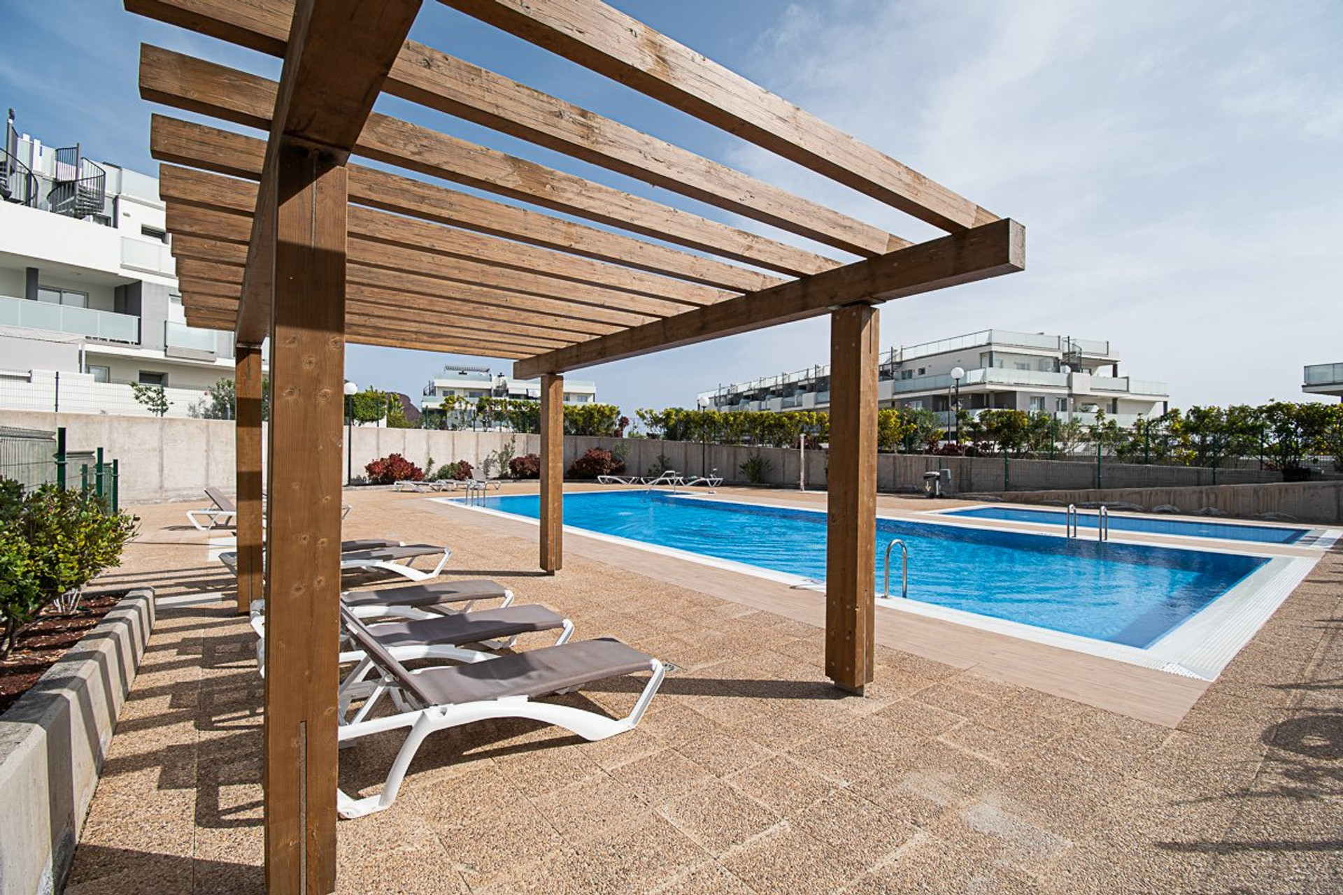 Pool area with pergola sunbeds