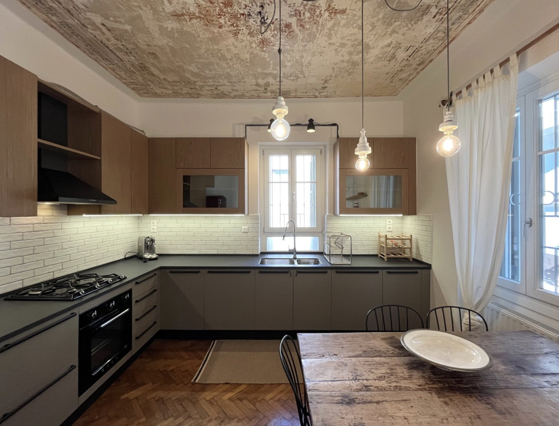 Stylish kitchen with ornate ceiling