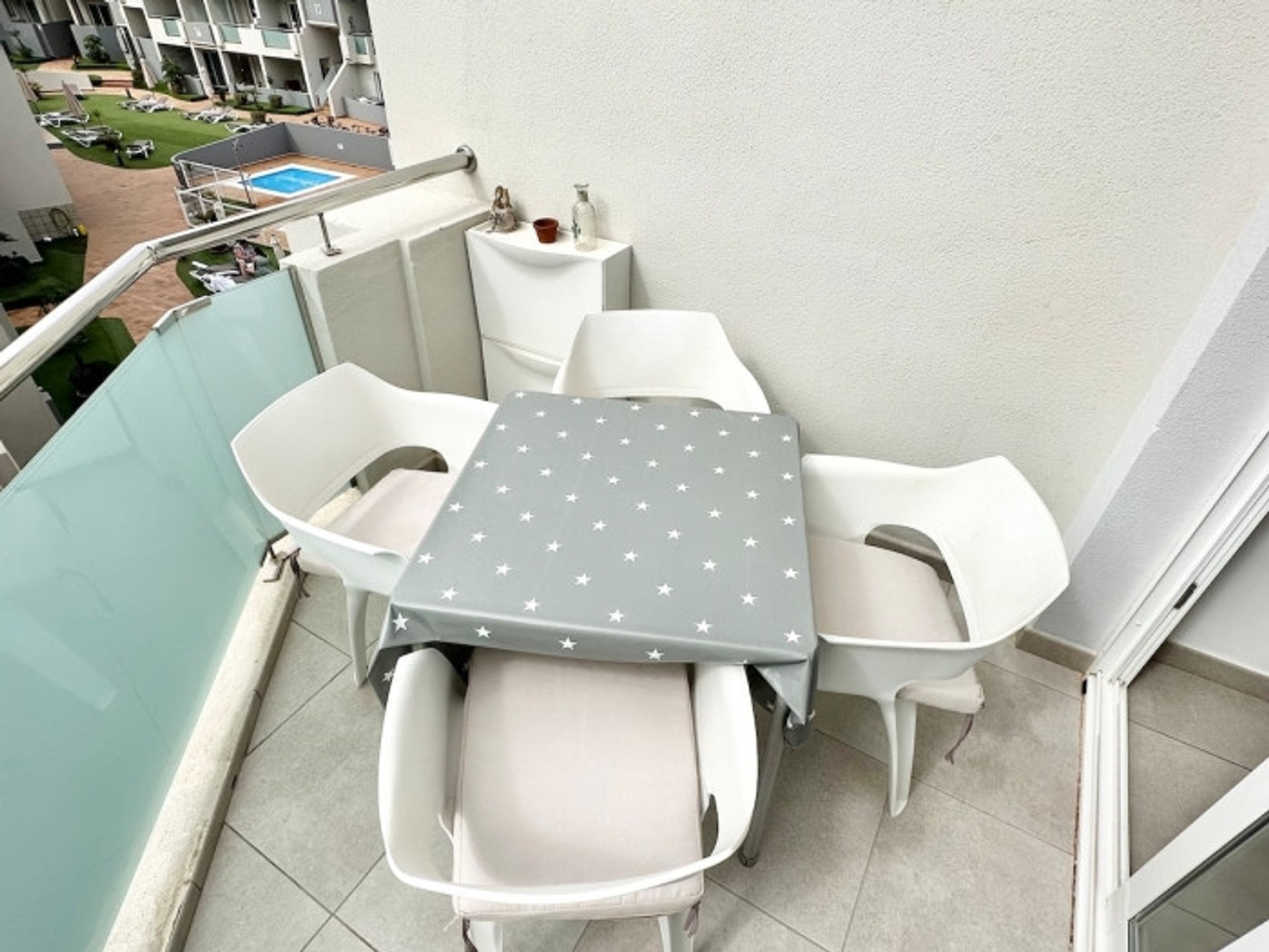 Balcony with table and pool view